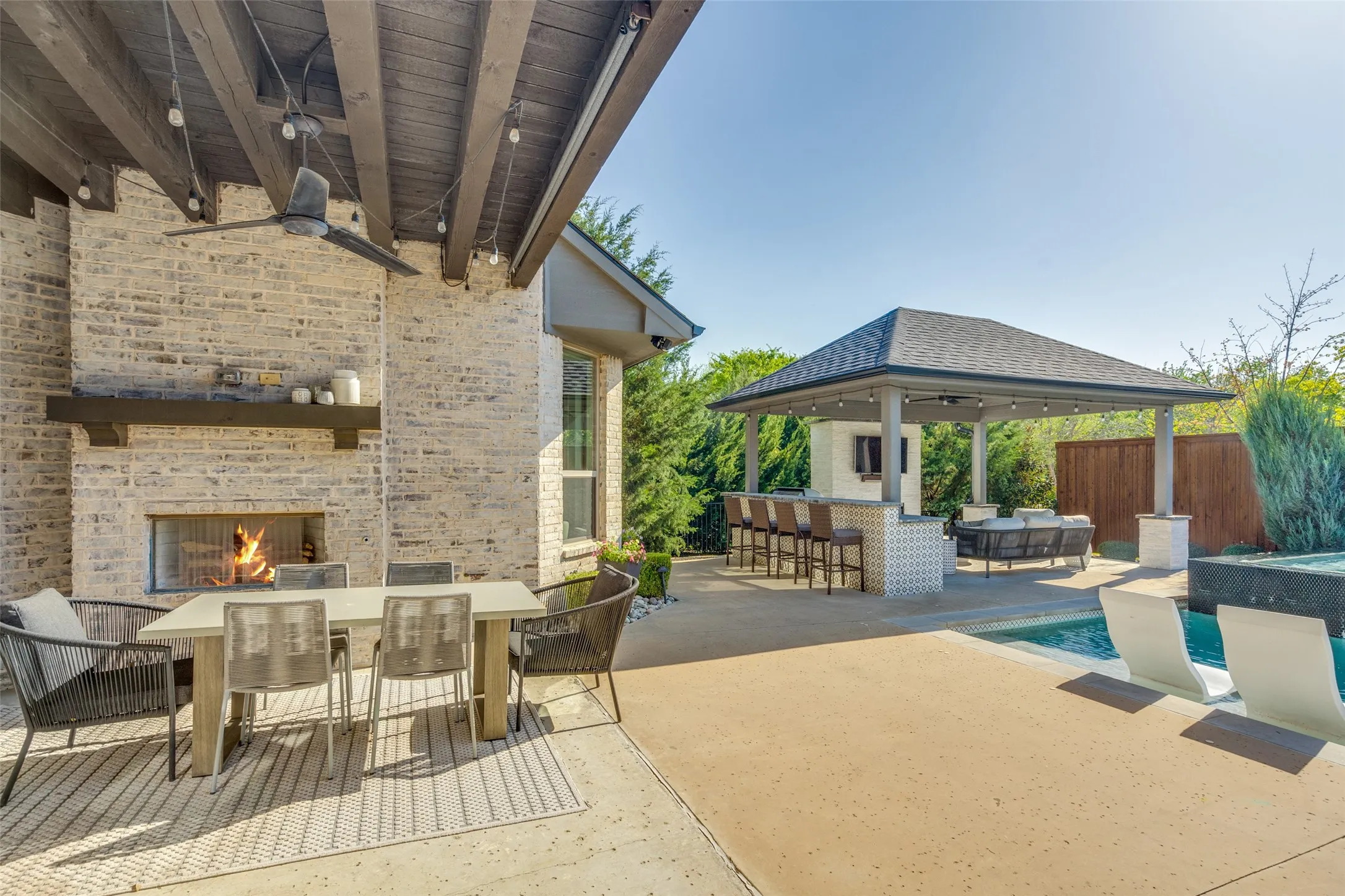 Covered patio with fireplace and outdoor kitchen