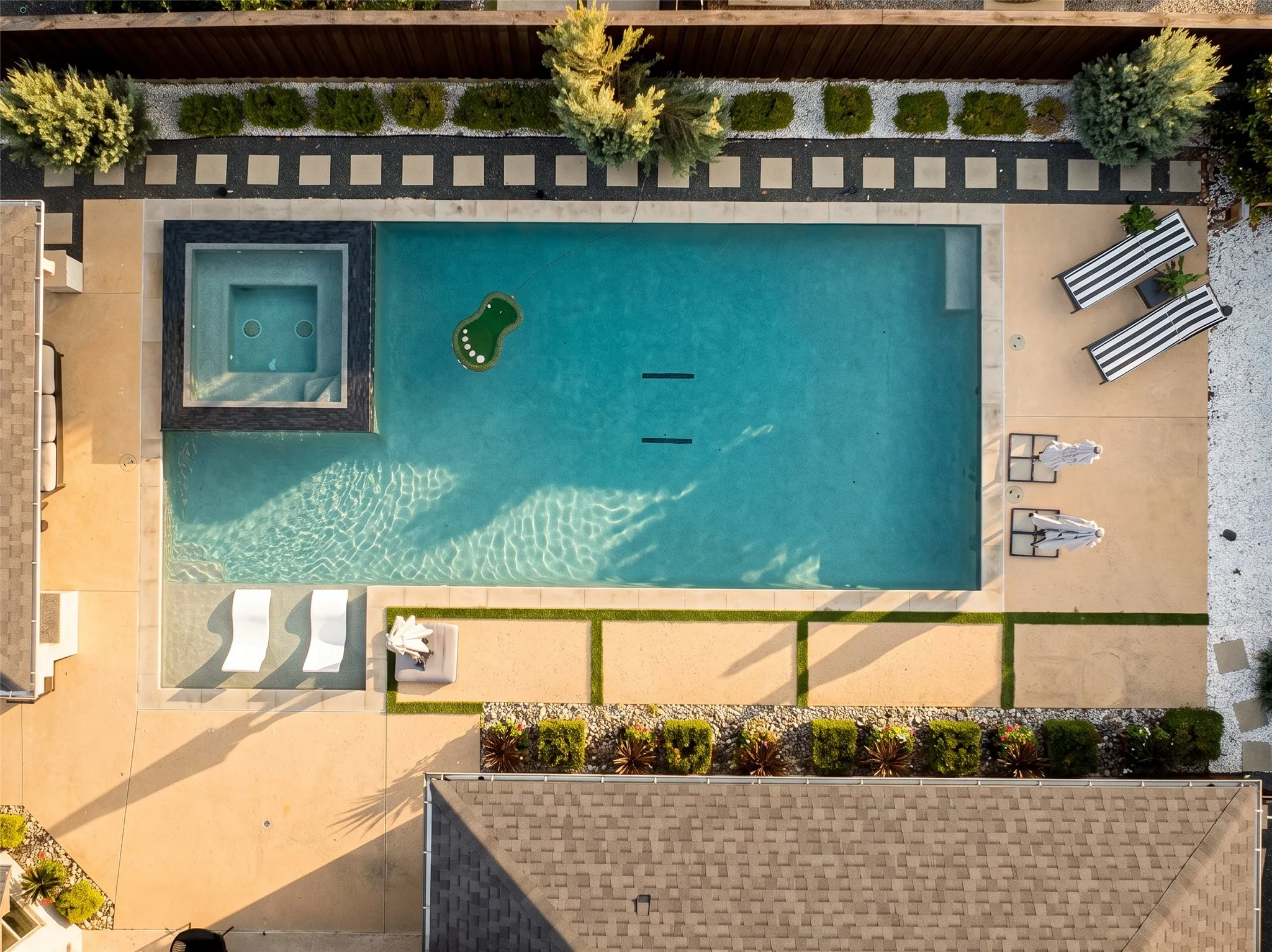 Custom pool with infinity edge spa creating a private backyard oasis