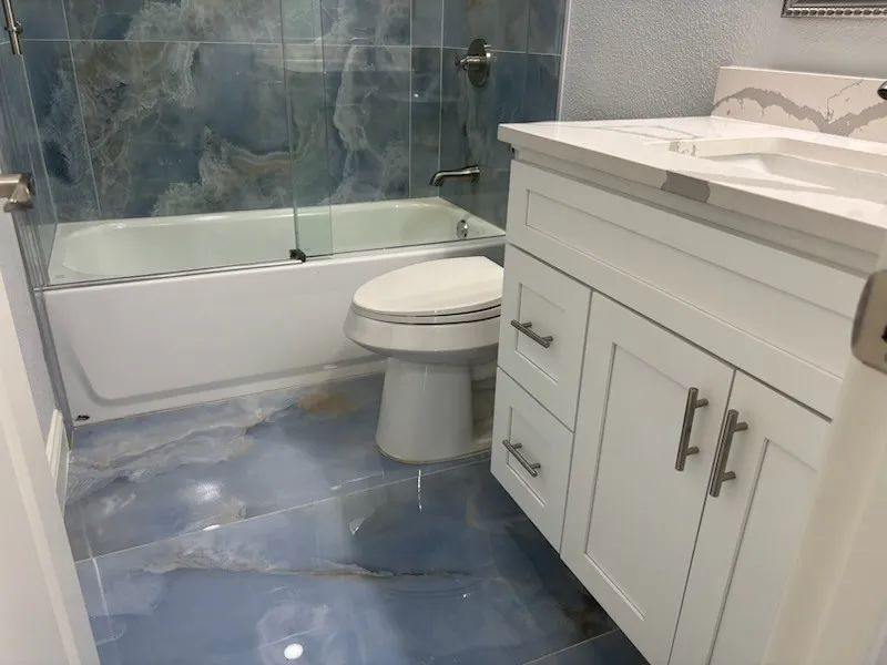 Gorgeous porcelain tile in hall bath and granite countertops