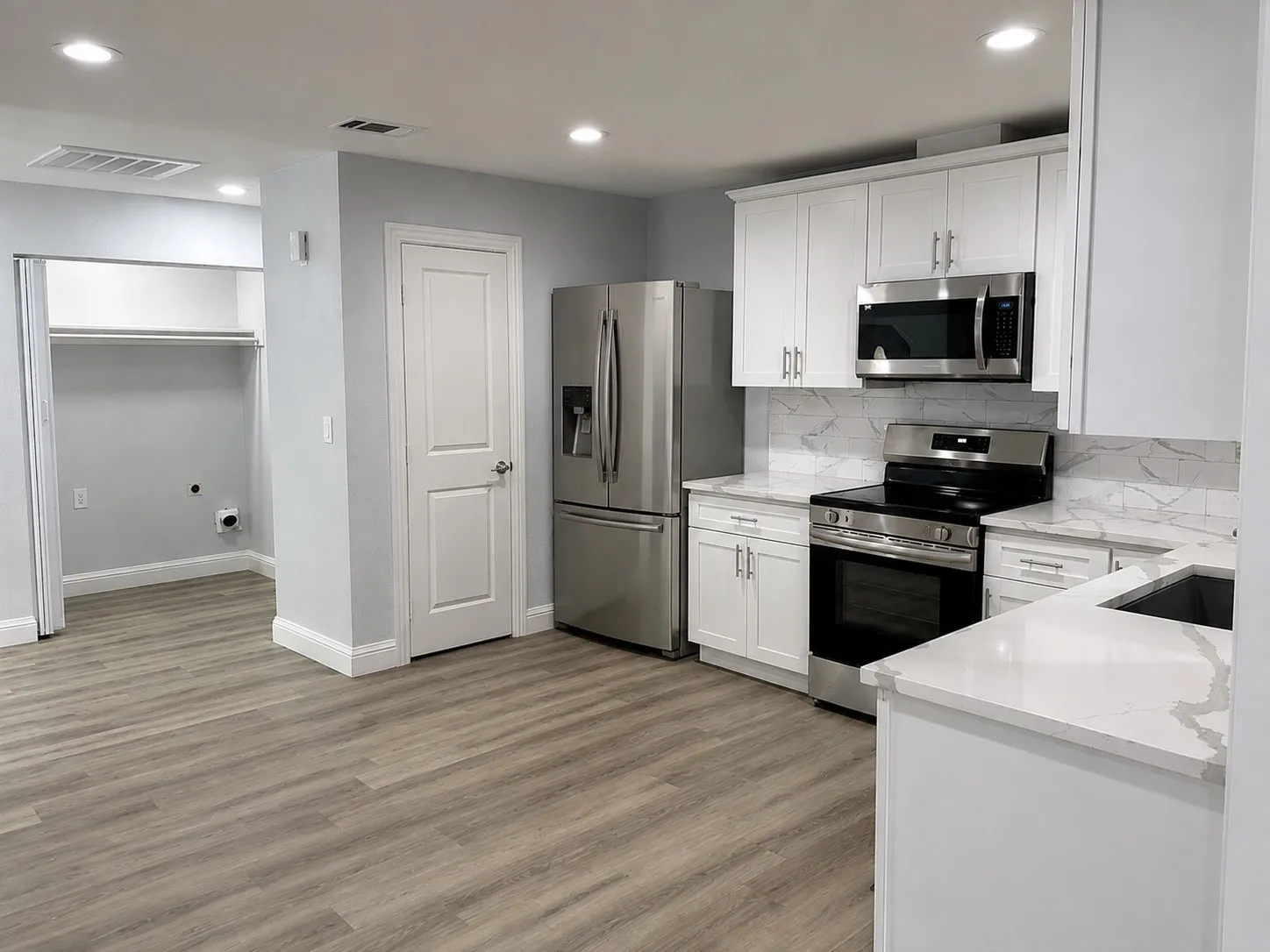 Digitally Enhanced and Fridge added:  Open kitchen with granite counters, stainless appliances and white cabinets.