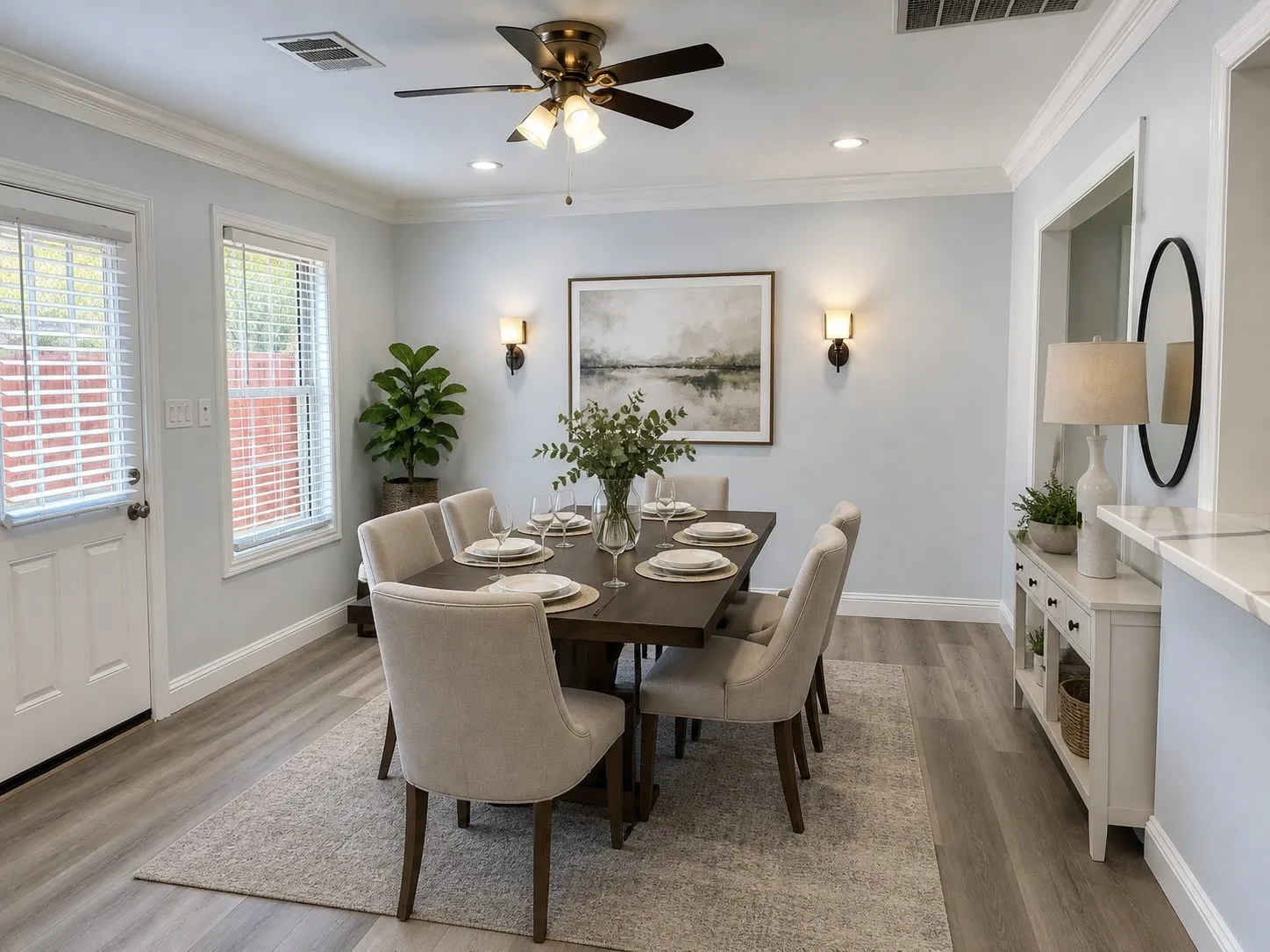Digitally Enhanced:  Formal dining area featuring luxury vinyl wood like flooring, a pass thru counter, a ceiling fan with integrated lighting, recessed lighting, and digitally enhanced wall sconces