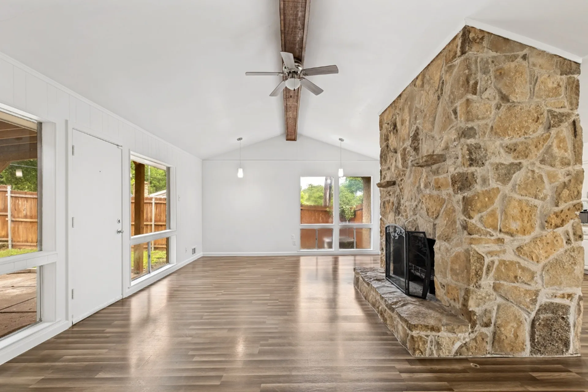 Vaulted ceiling featuring a wood beam and ceiling fan
