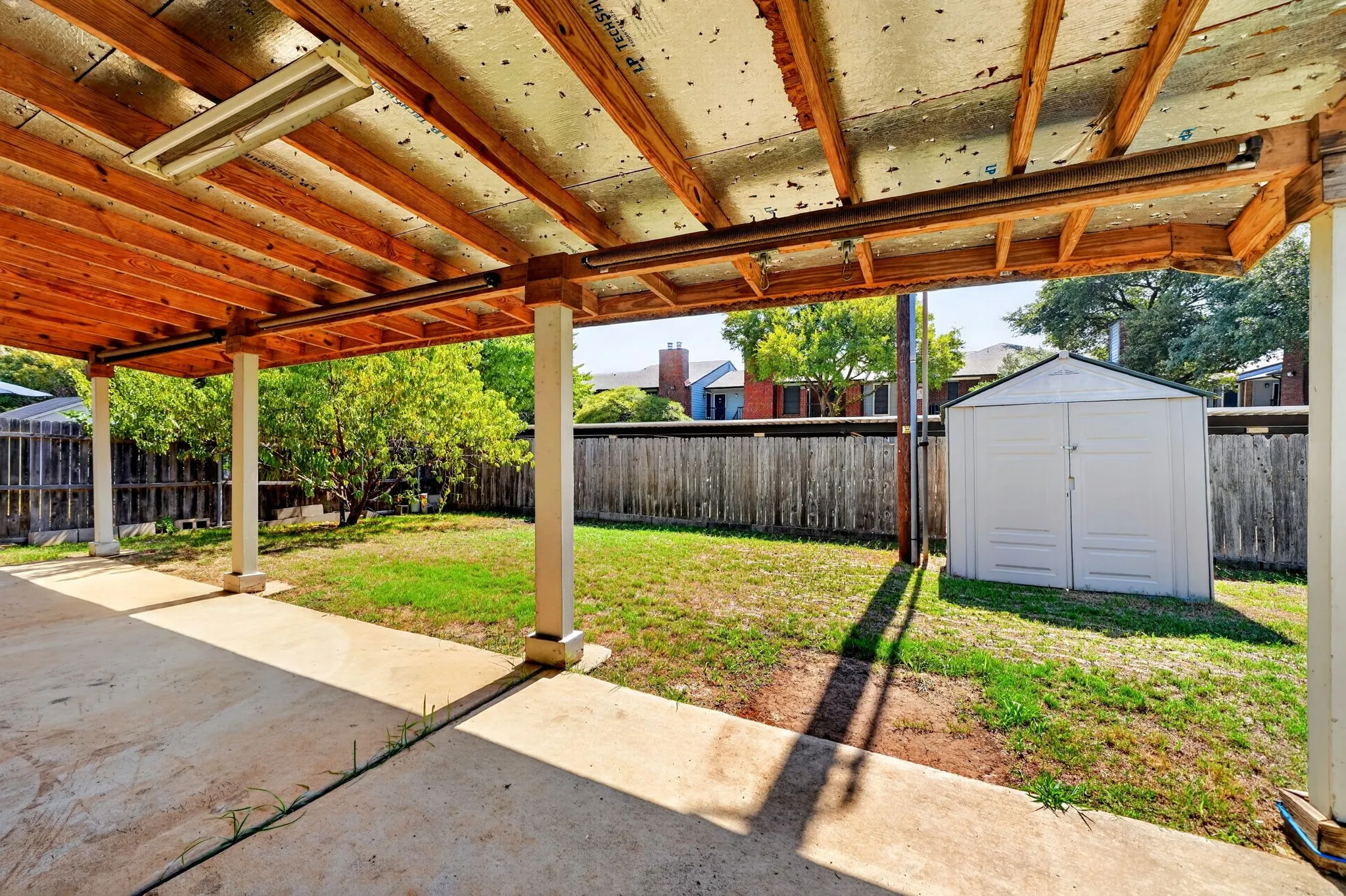 Covered patio featuring a concrete slab and exposed wood beam ceiling