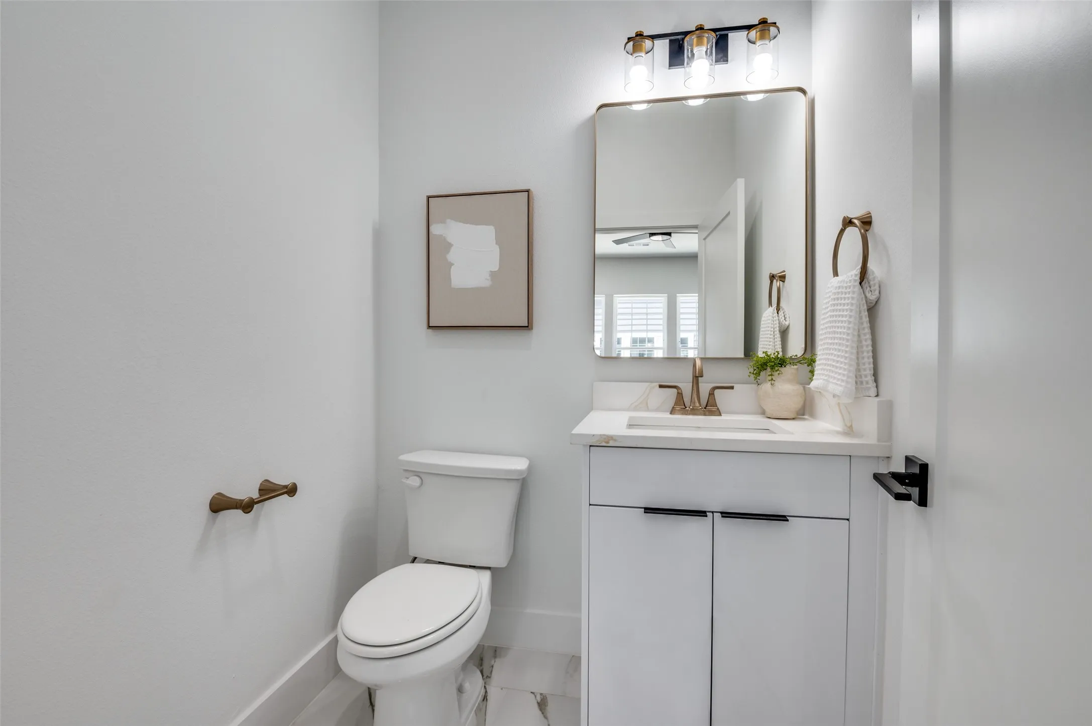 Bathroom featuring vanity and marble look tile flooring