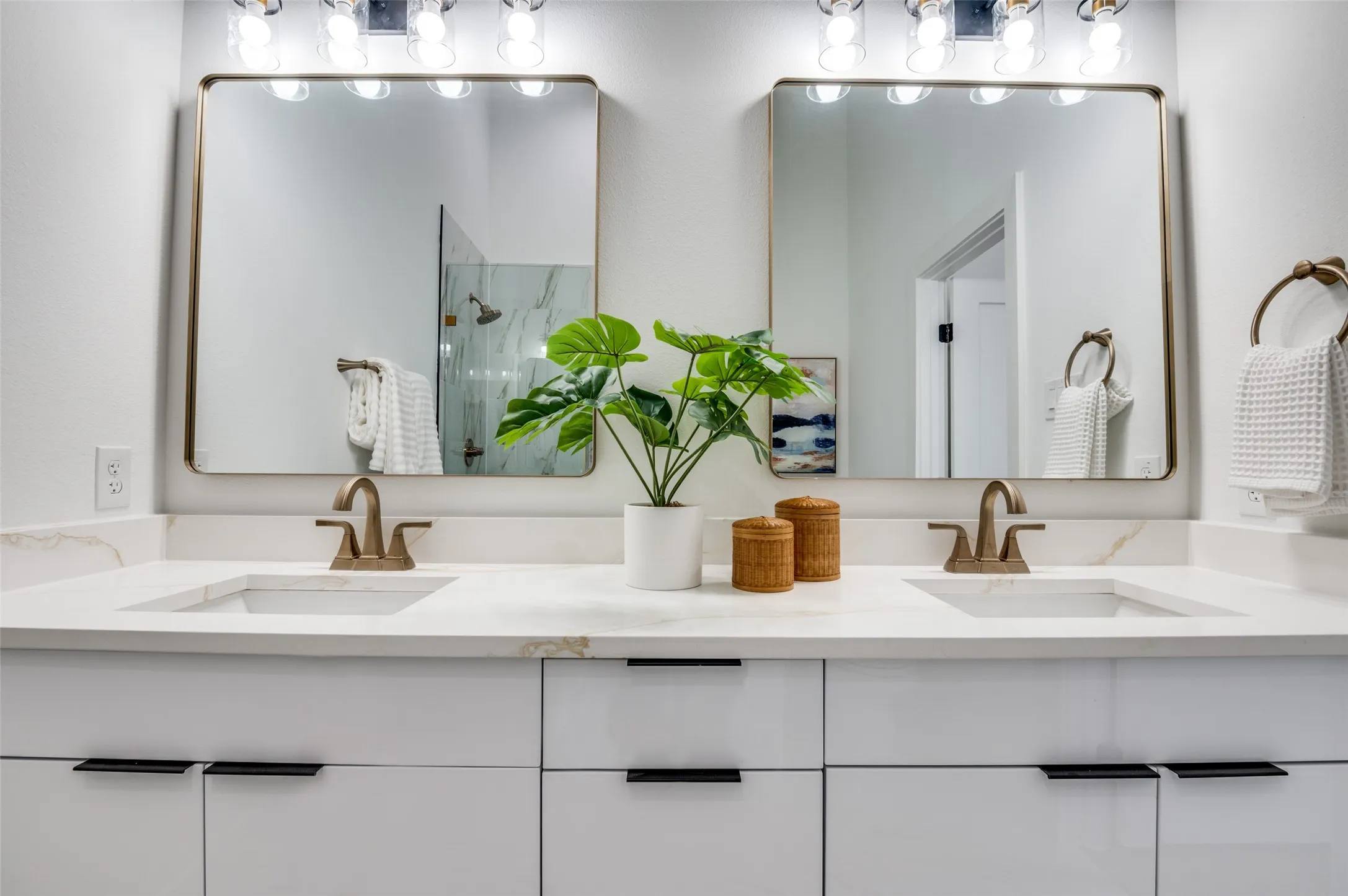 Bathroom with a marble finish shower and double vanity