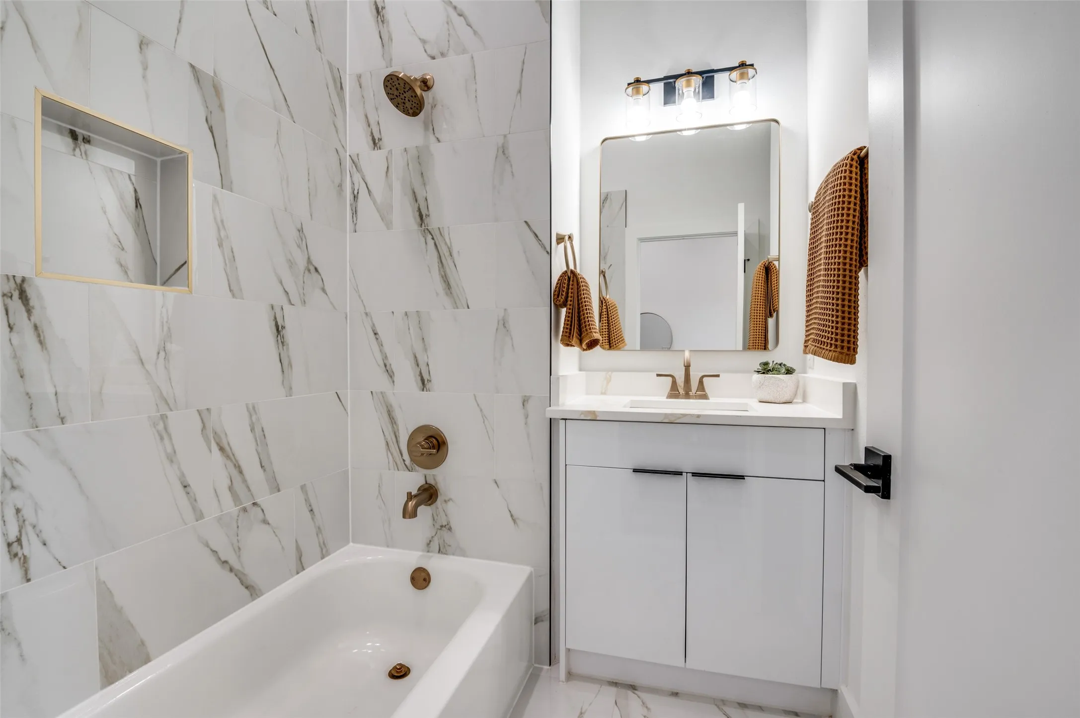 Full bathroom with vanity, bathtub / shower combination, and marble finish floors