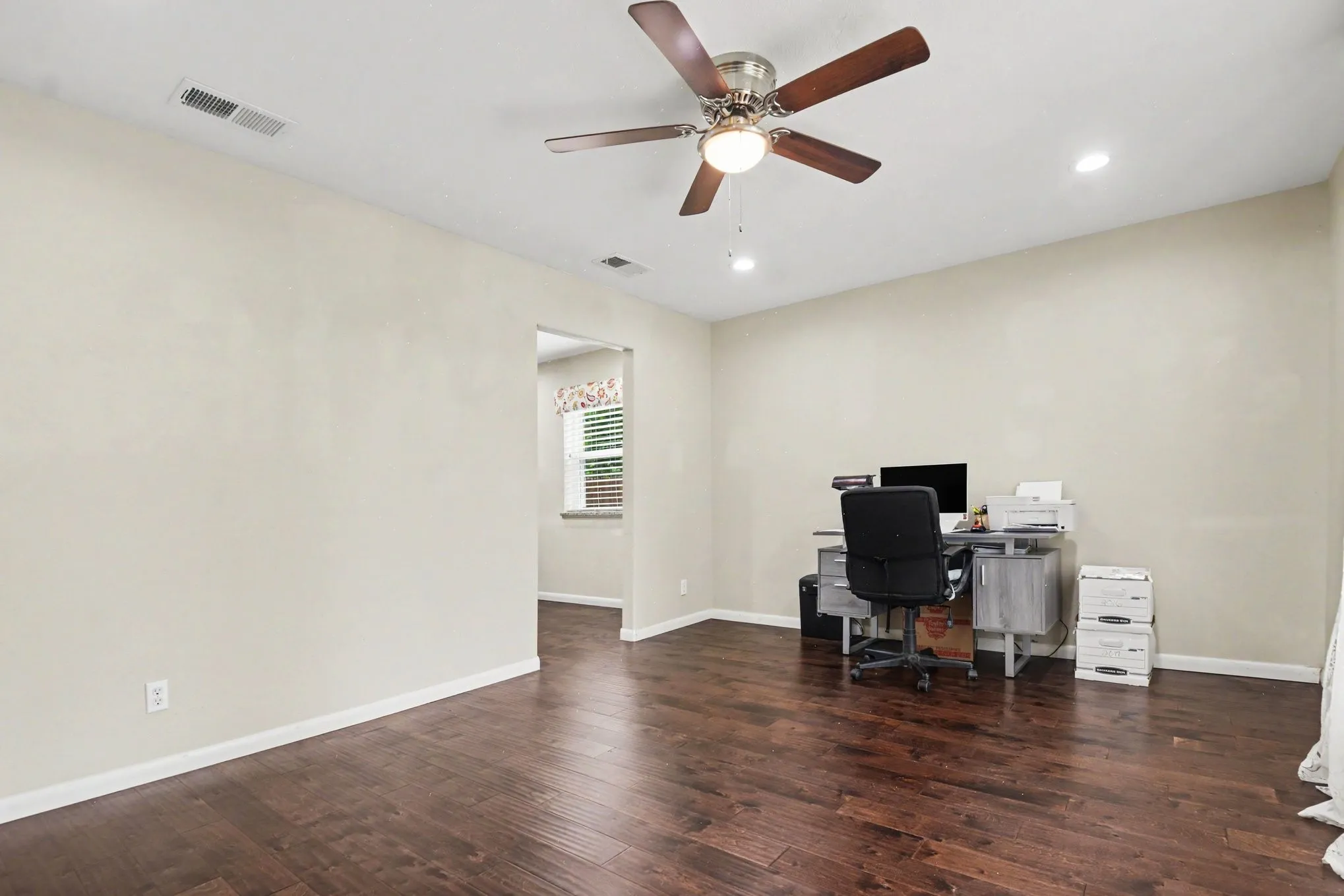 Hardwood-finish flooring, recessed lighting, and a ceiling fan with light fixture