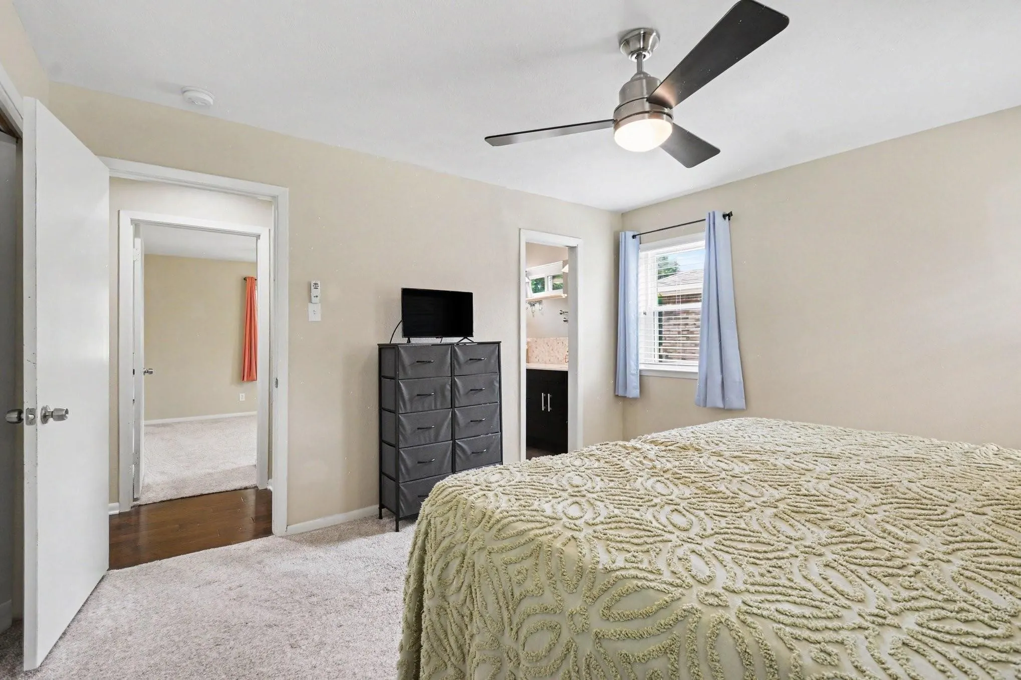 Recessed window with blinds, ceiling fan with integrated lighting, and neutral wall paint