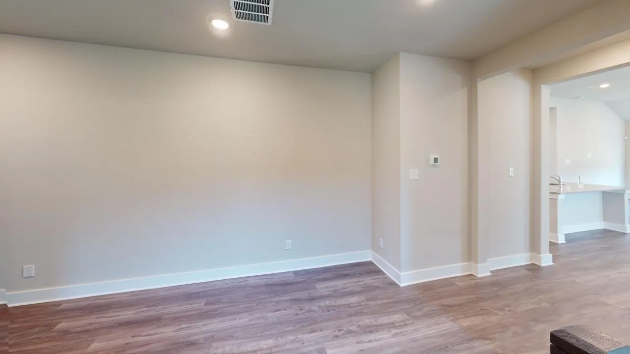 Recessed lighting, wood-finish flooring, and crisp white trim