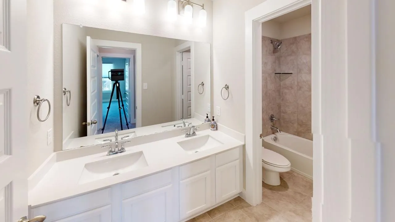 Double vanity with white cabinetry and integrated sinks
