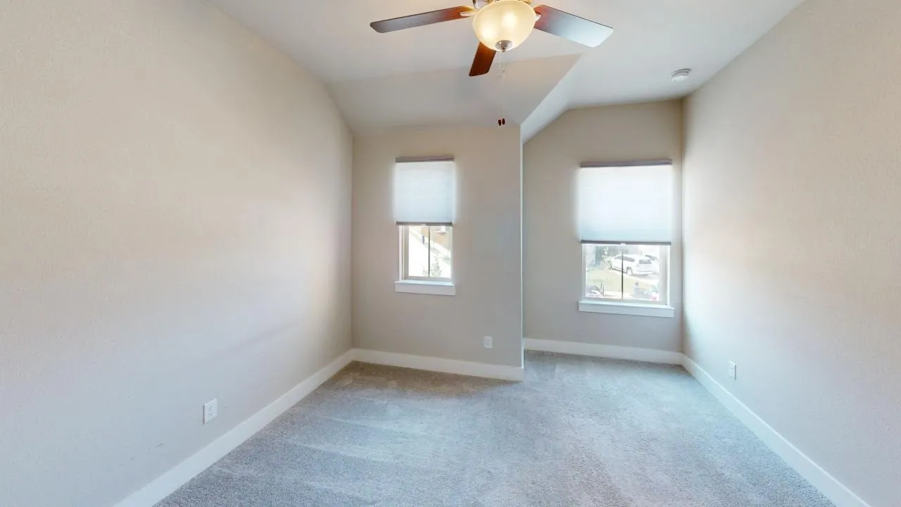 Neutral wall finishes, recessed lighting, and a ceiling fan with integrated light
