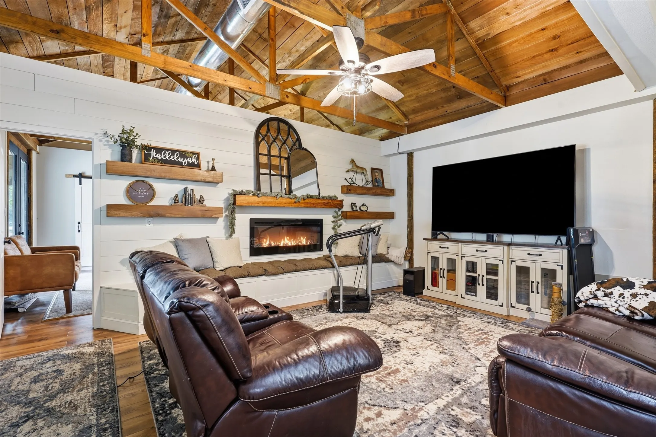 den area off of the master bedroom and main family room with vaulted ceilings and fireplace