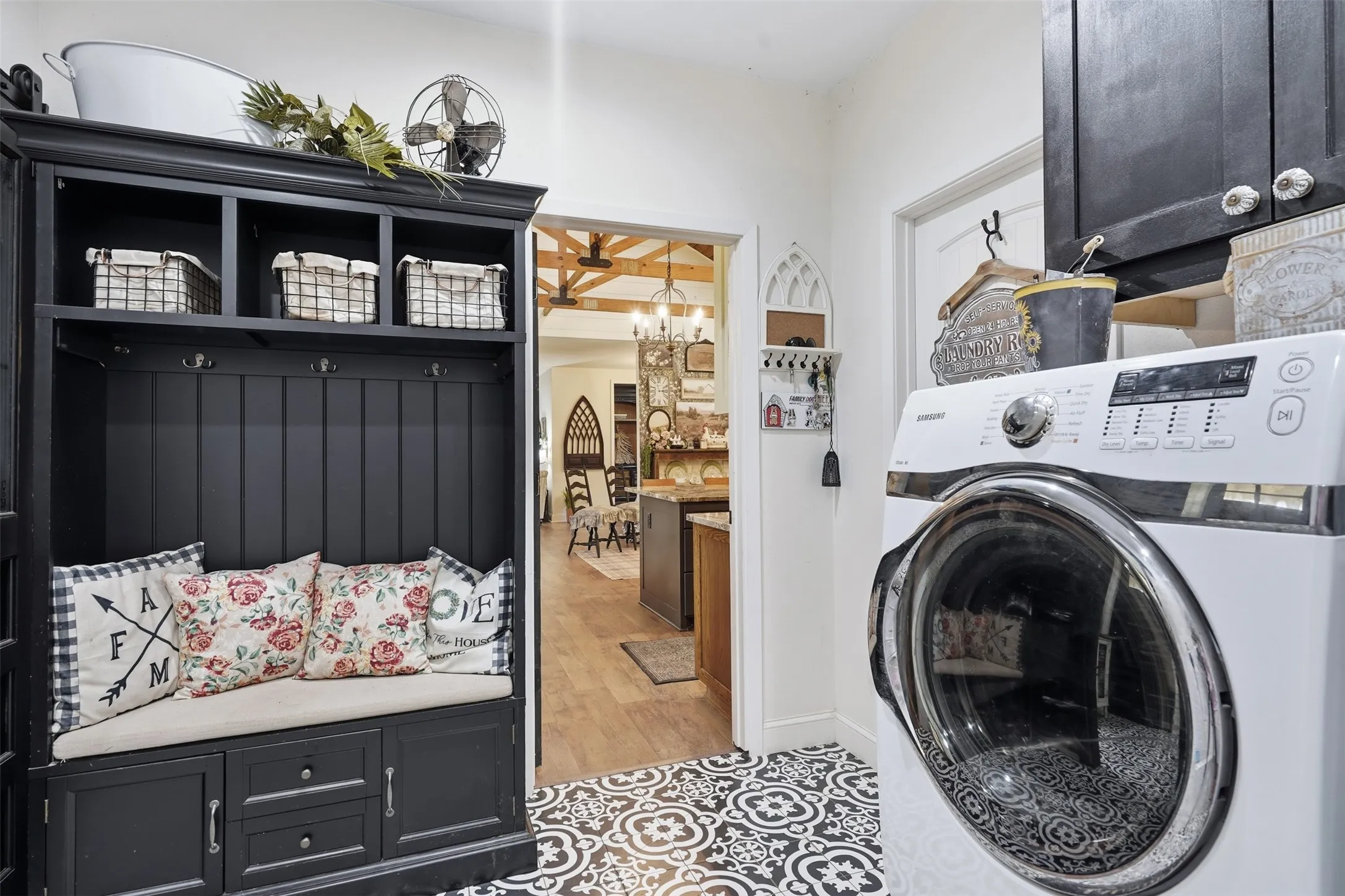utility room off of the garage with dog washing station and extra storage room