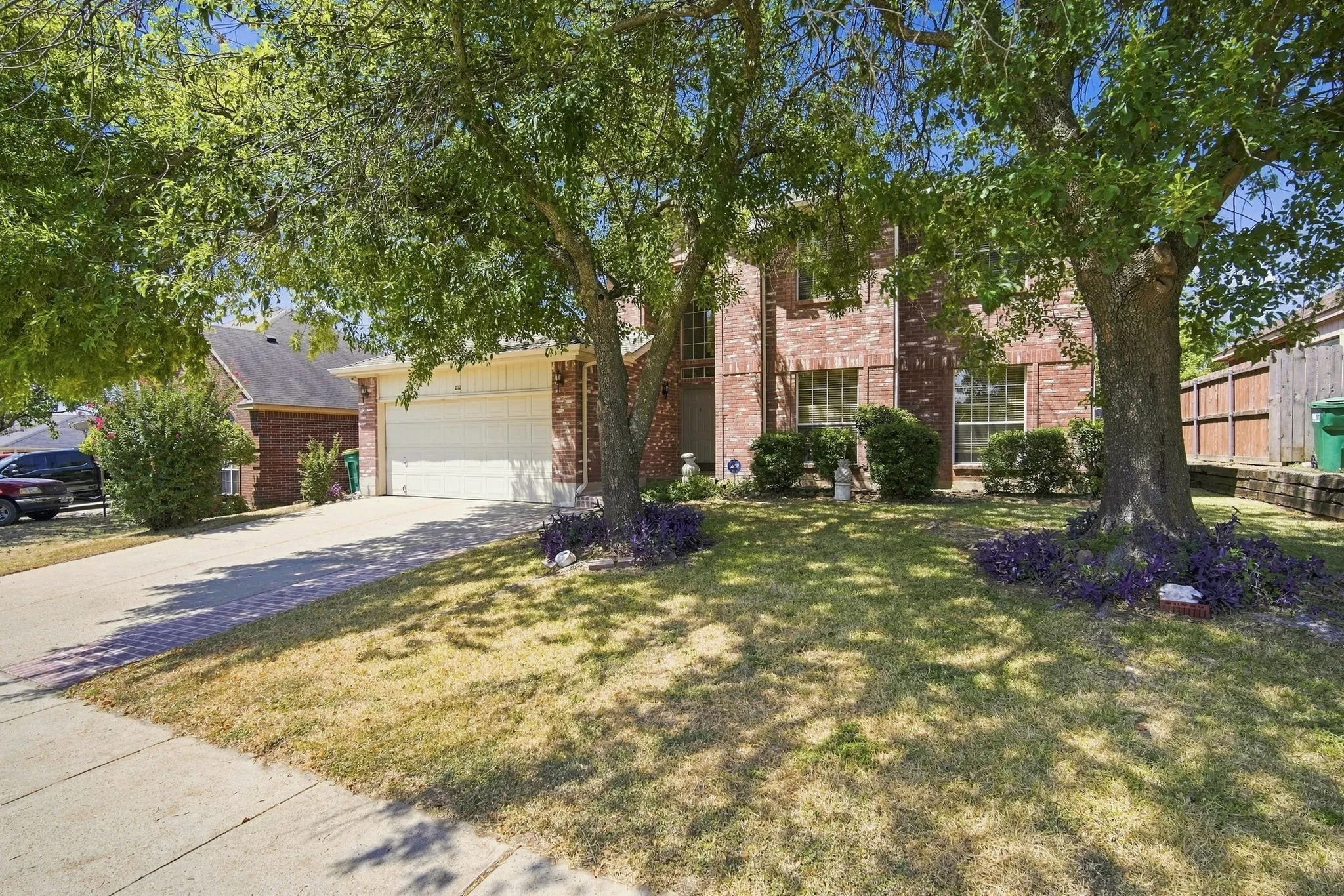 Brick exterior with a two-car garage and a concrete driveway