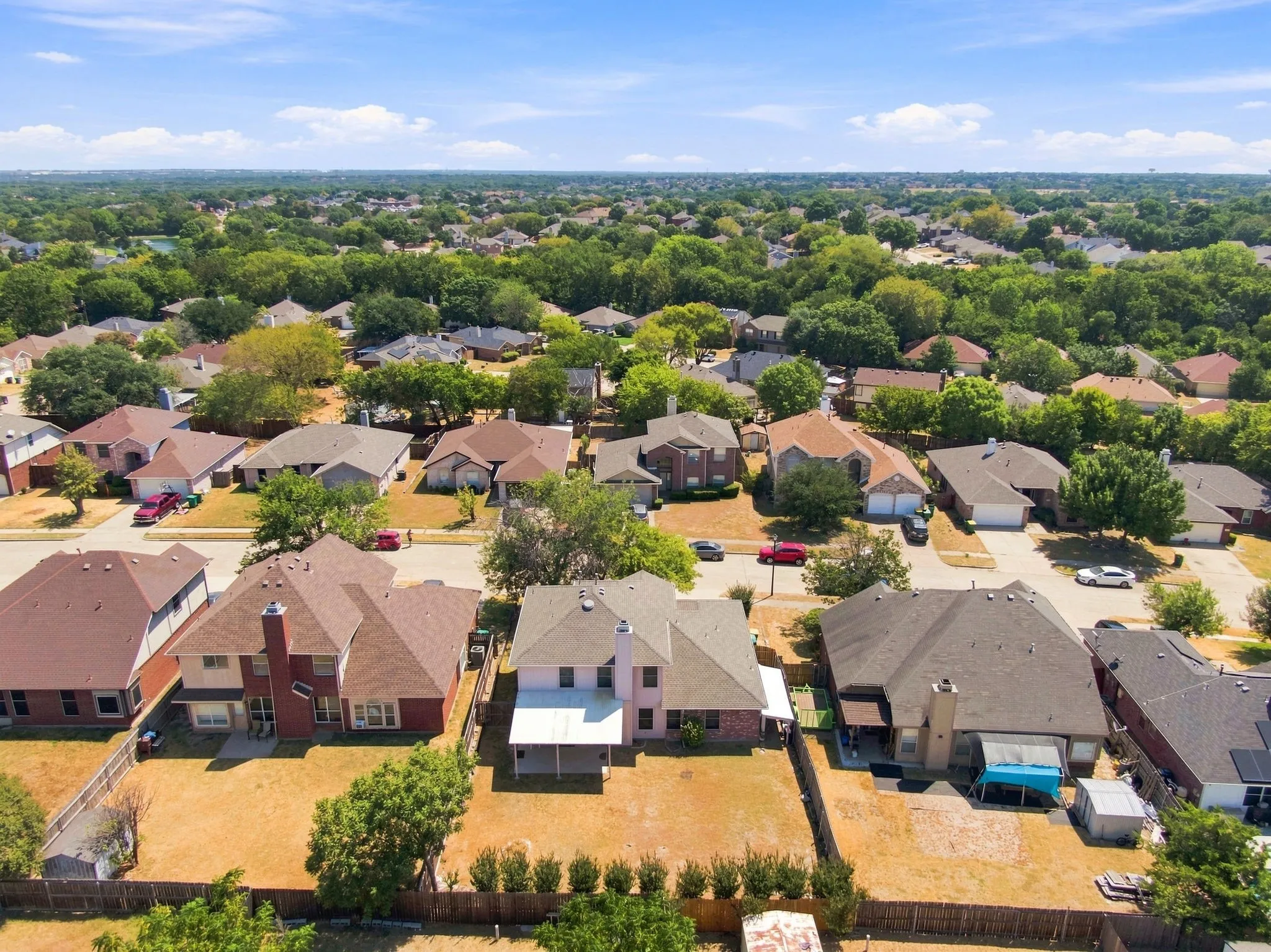 Aerial perspective showcasing a residential neighborhood with varied architectural styles and mature trees