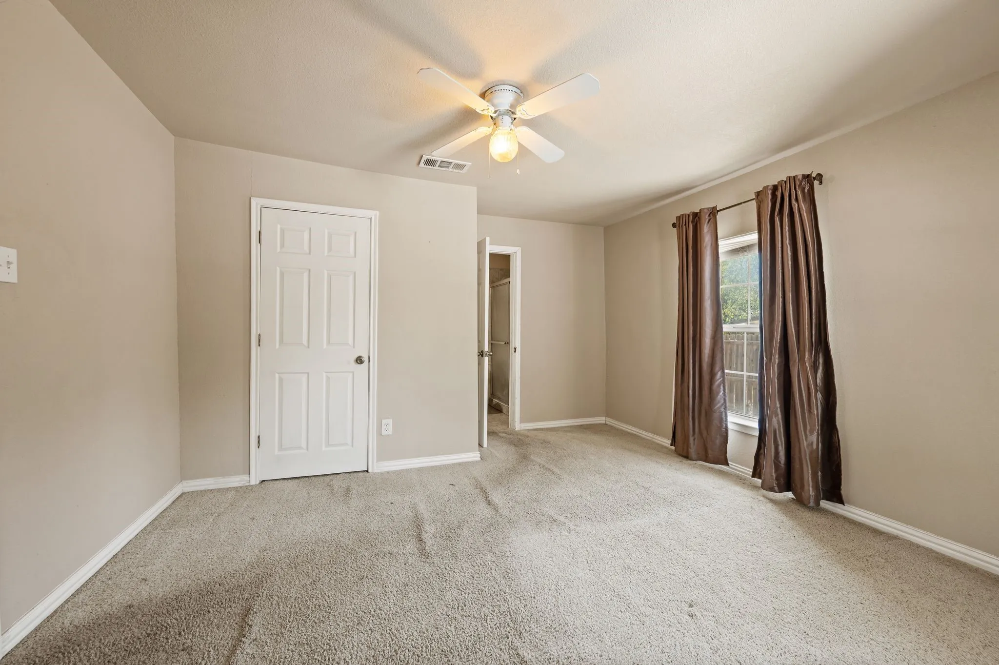Carpeted interior with light-toned walls and white trim