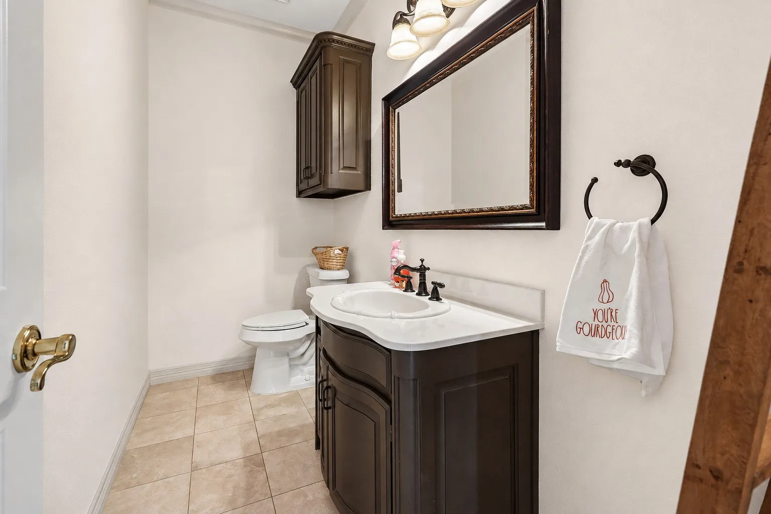 Vanity with an integrated sink, dark wood-finish cabinetry, and a white countertop