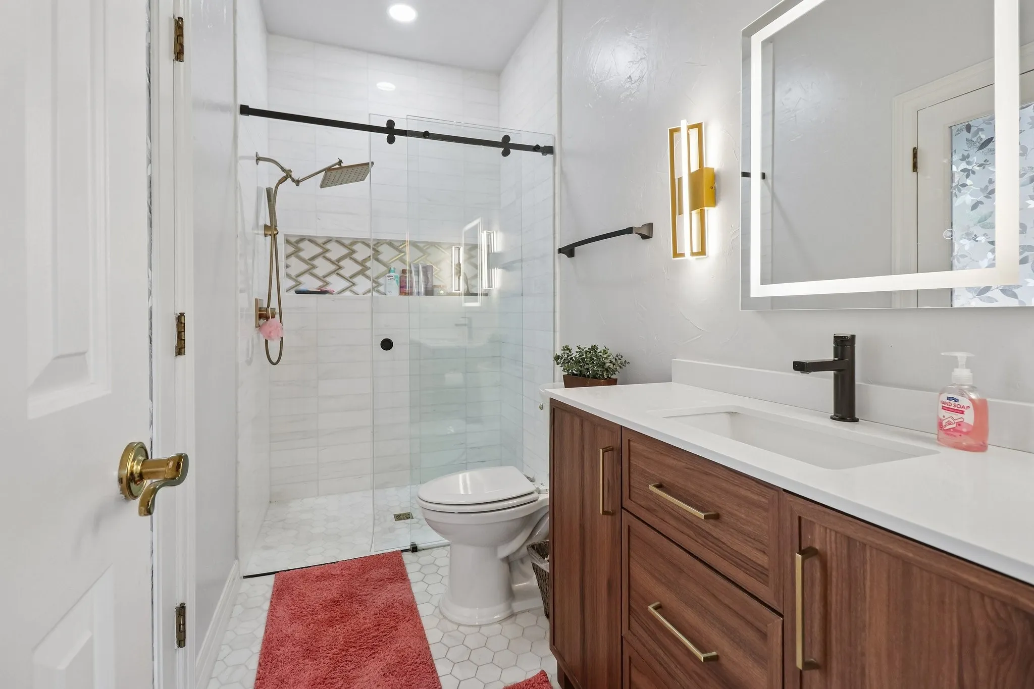 Modern vanity with wood-finish cabinetry, integrated sink, and matte black faucet