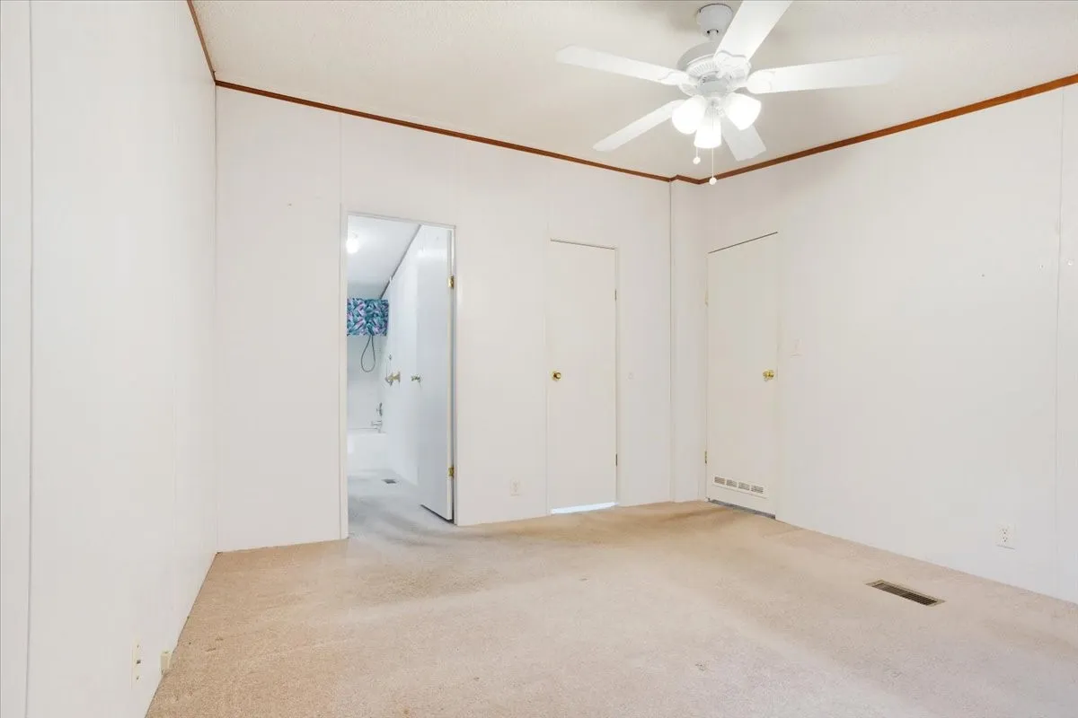 Primary bed looking into bath, closet, and entry