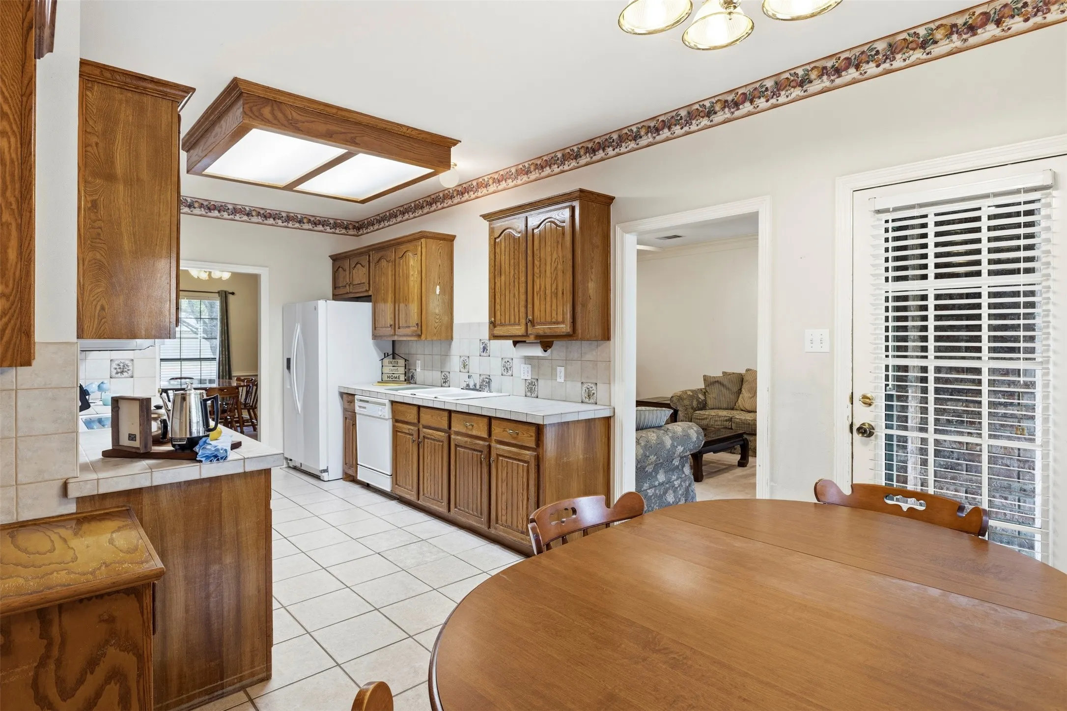 A folding counter and cabinets above the washer and dryer.