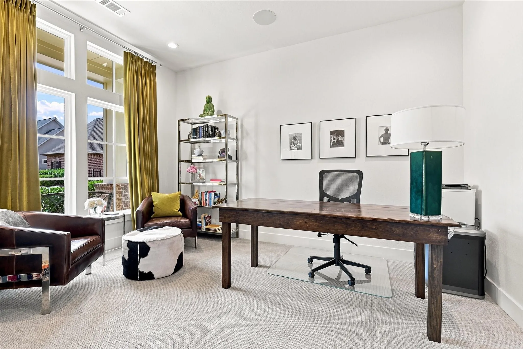 Spacious room featuring tall windows with transom details, light-toned carpet flooring, recessed lighting, and a built-in ceiling speaker