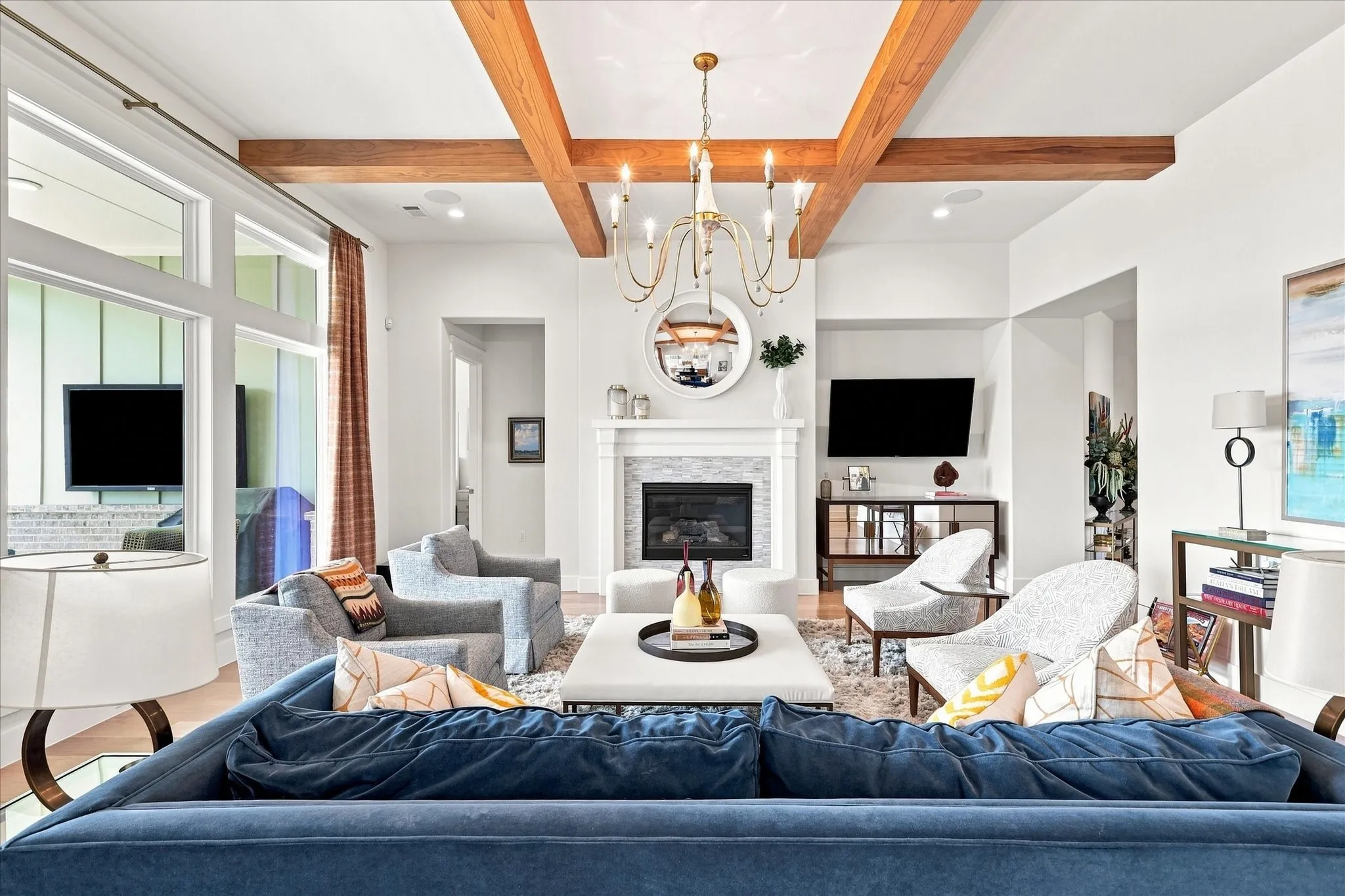 Vaulted ceiling with wood beams, recessed lighting, and a chandelier