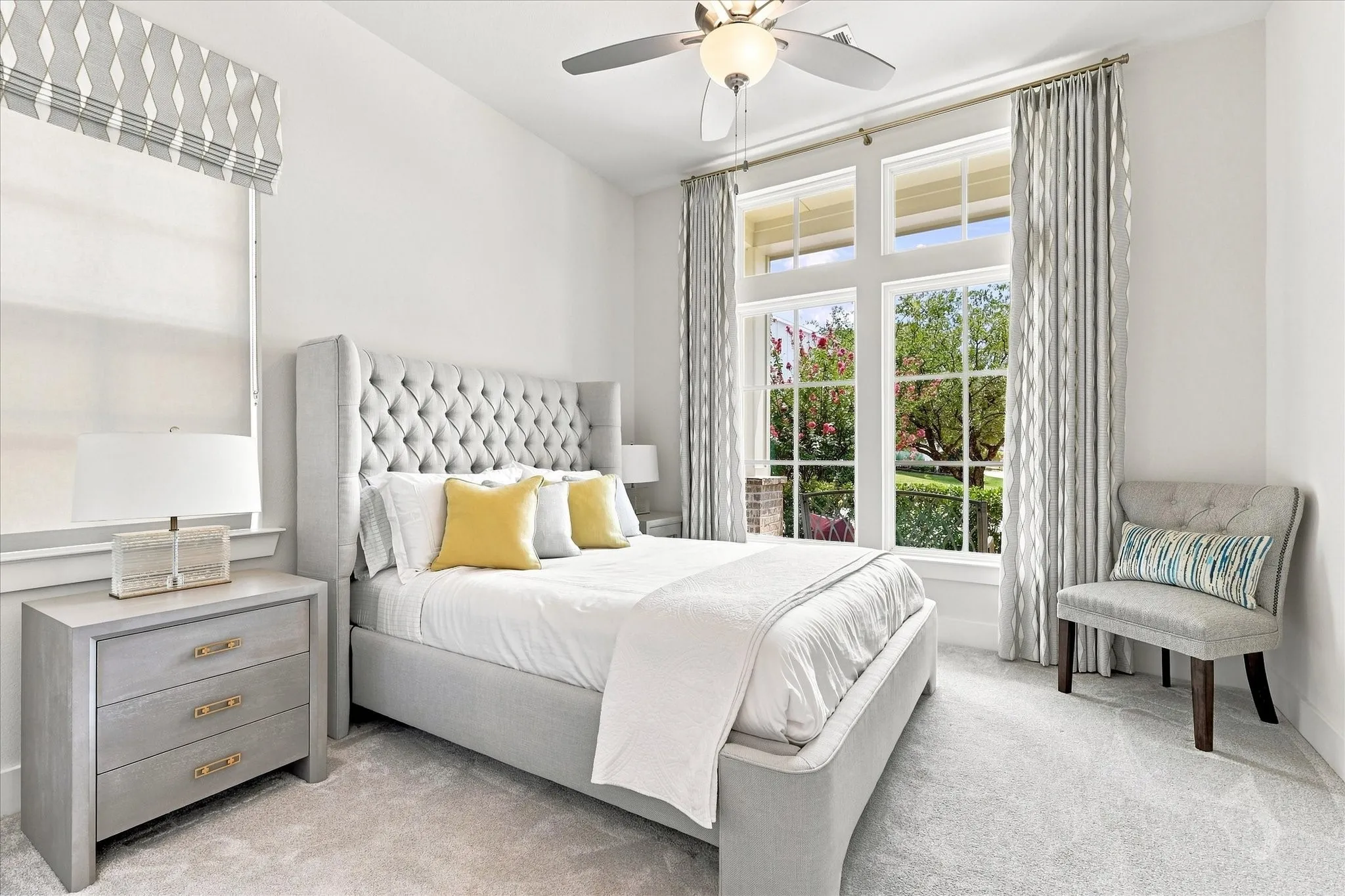 Plush carpet flooring, a multi-pane window, and a ceiling fan with integrated lighting
