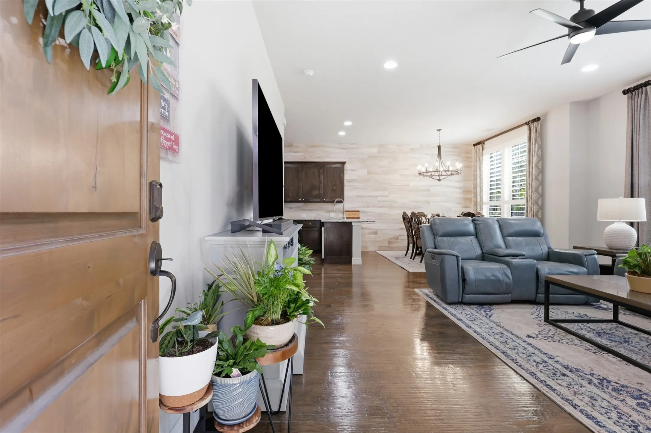 Wood-finish flooring throughout, recessed lighting, and a modern ceiling fan