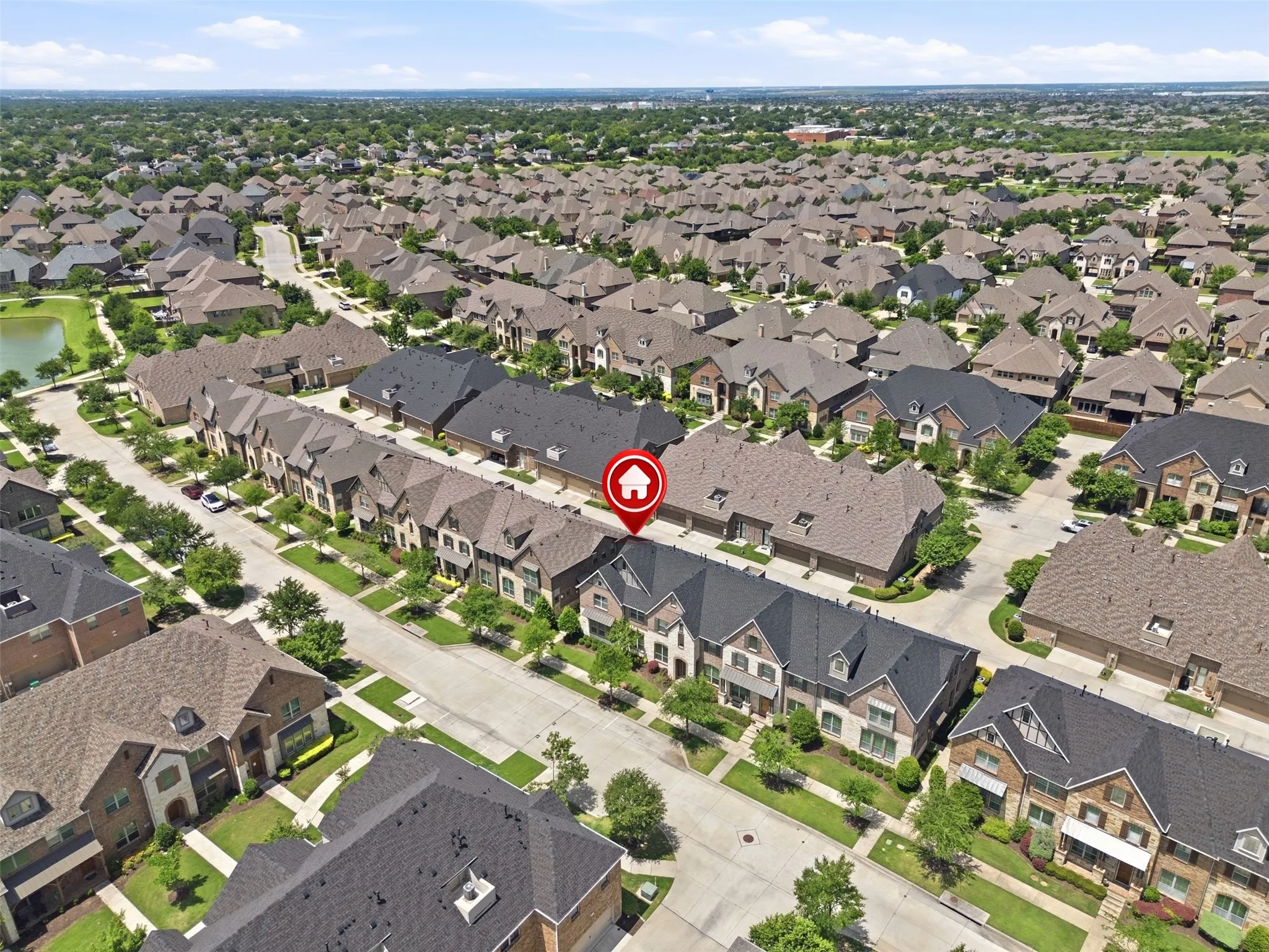 Residential neighborhood with a structured street grid and varied roofing materials