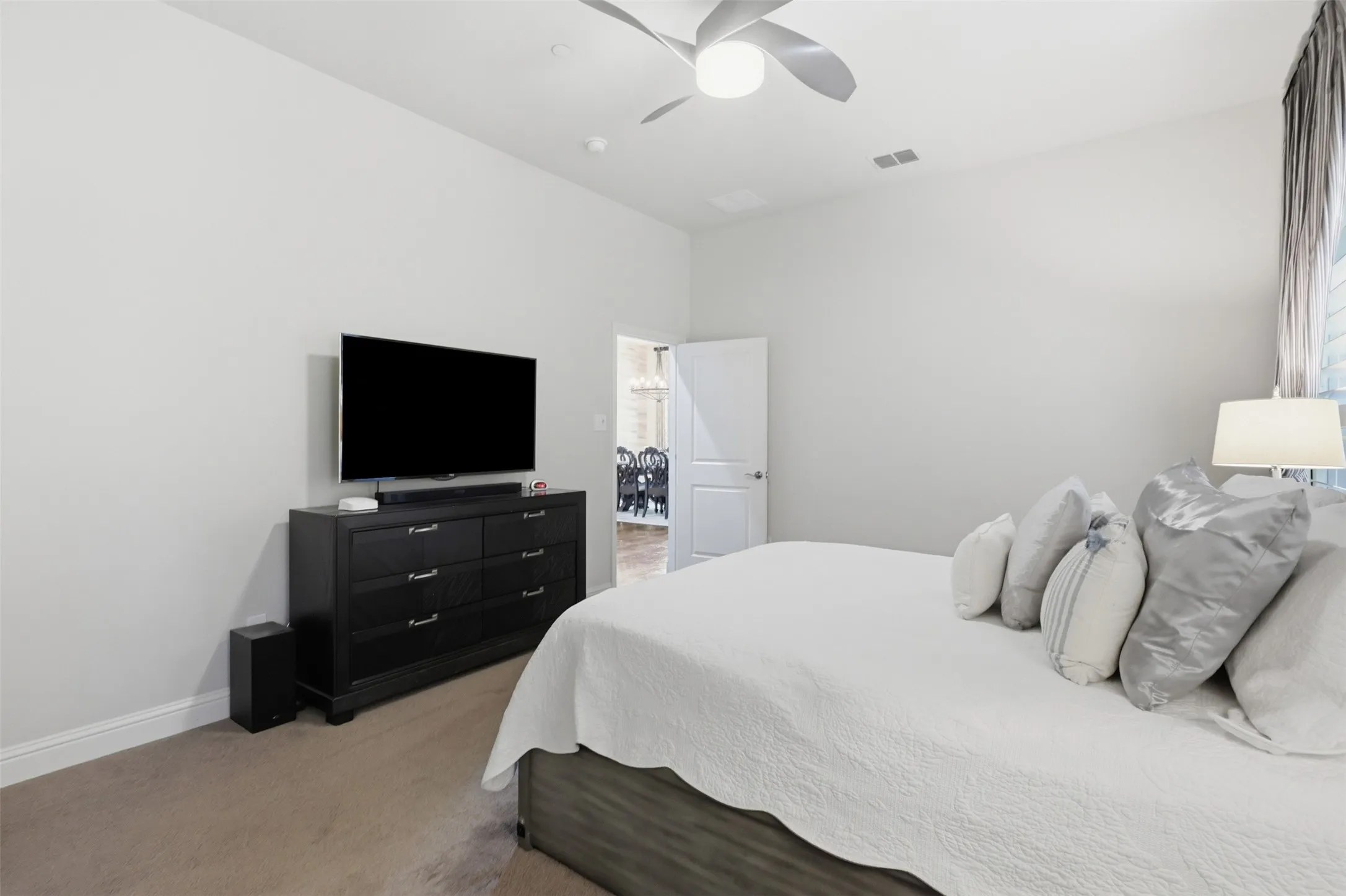 Wood-finish flooring with neutral wall tones and a ceiling fan