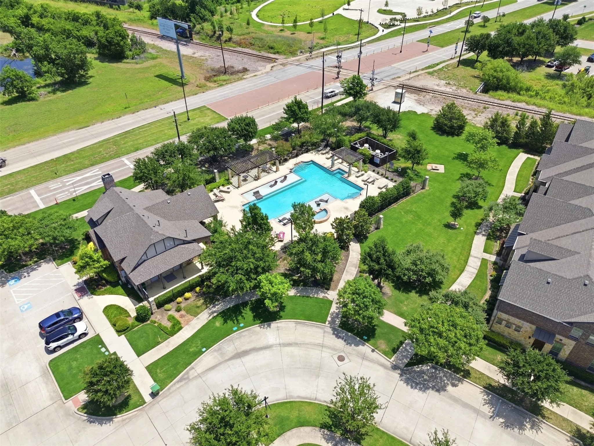 Central swimming pool with integrated spa and surrounding lounge areas