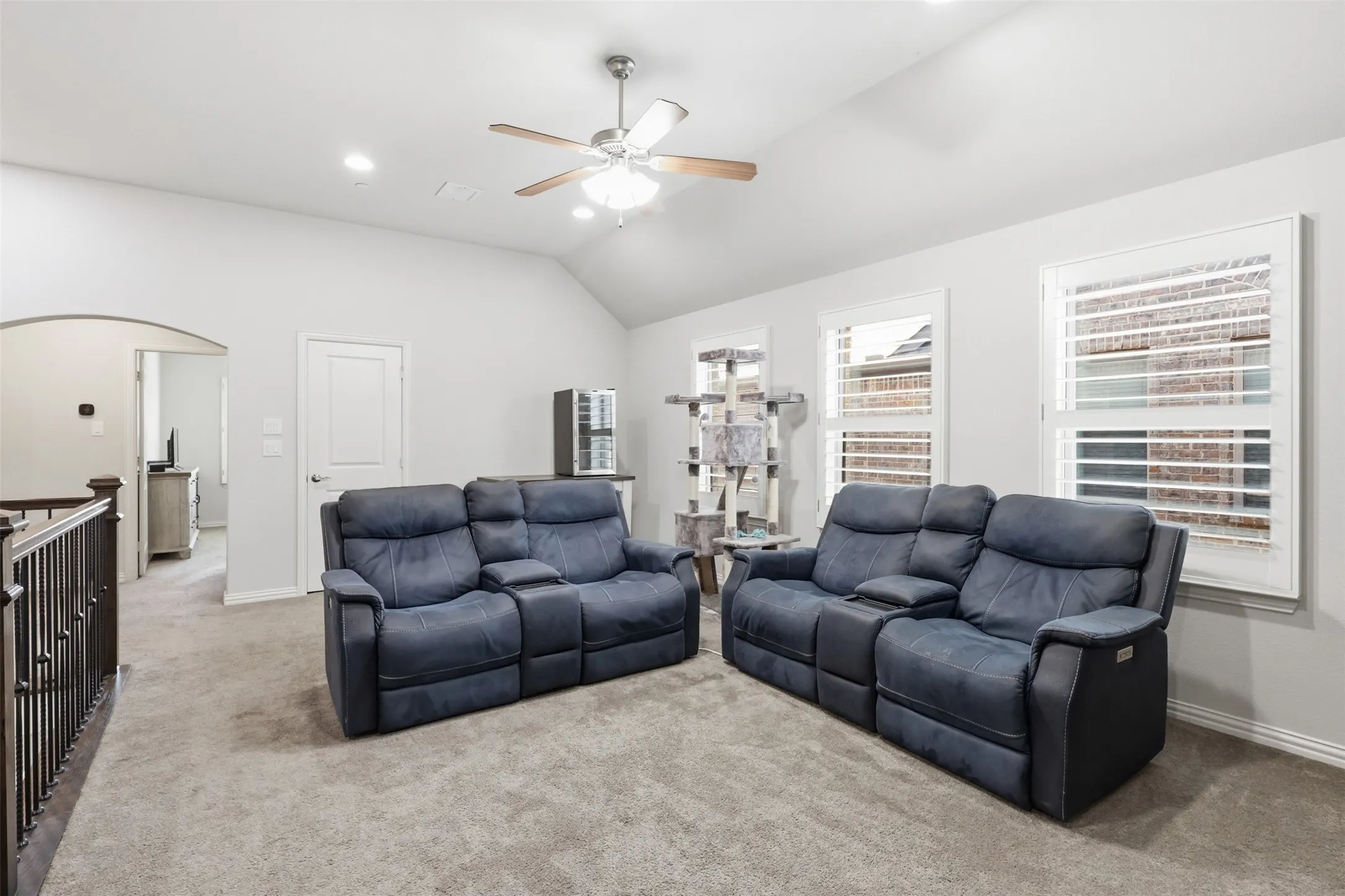 Carpeted room featuring a vaulted ceiling, recessed lighting, and a ceiling fan