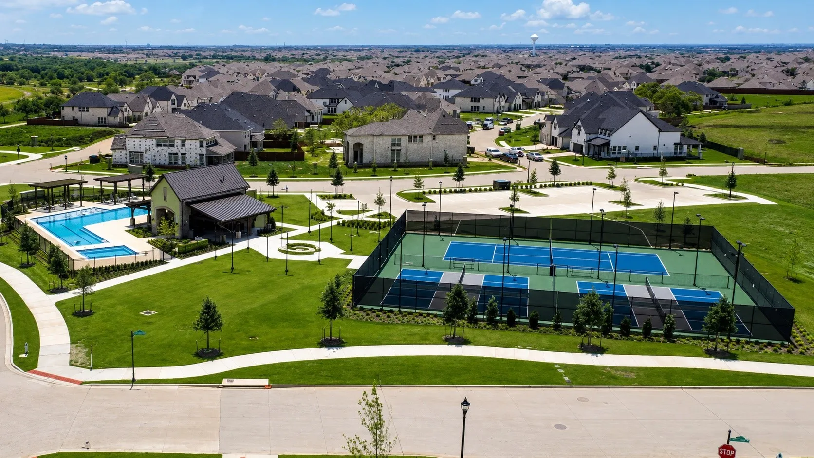 Community amenities featuring a swimming pool, covered lounge area, recreation building, multiple sports courts, and extensive green spaces
