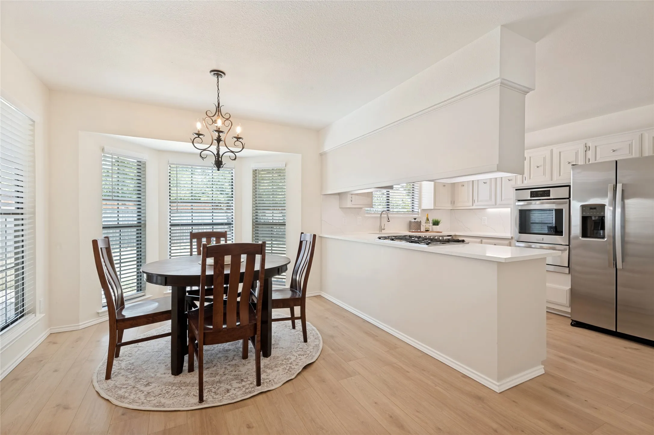 Bay windows surround the dining area just steps from the wet bar, providing a counter for mixing drinks, and a wall to store wine bottles