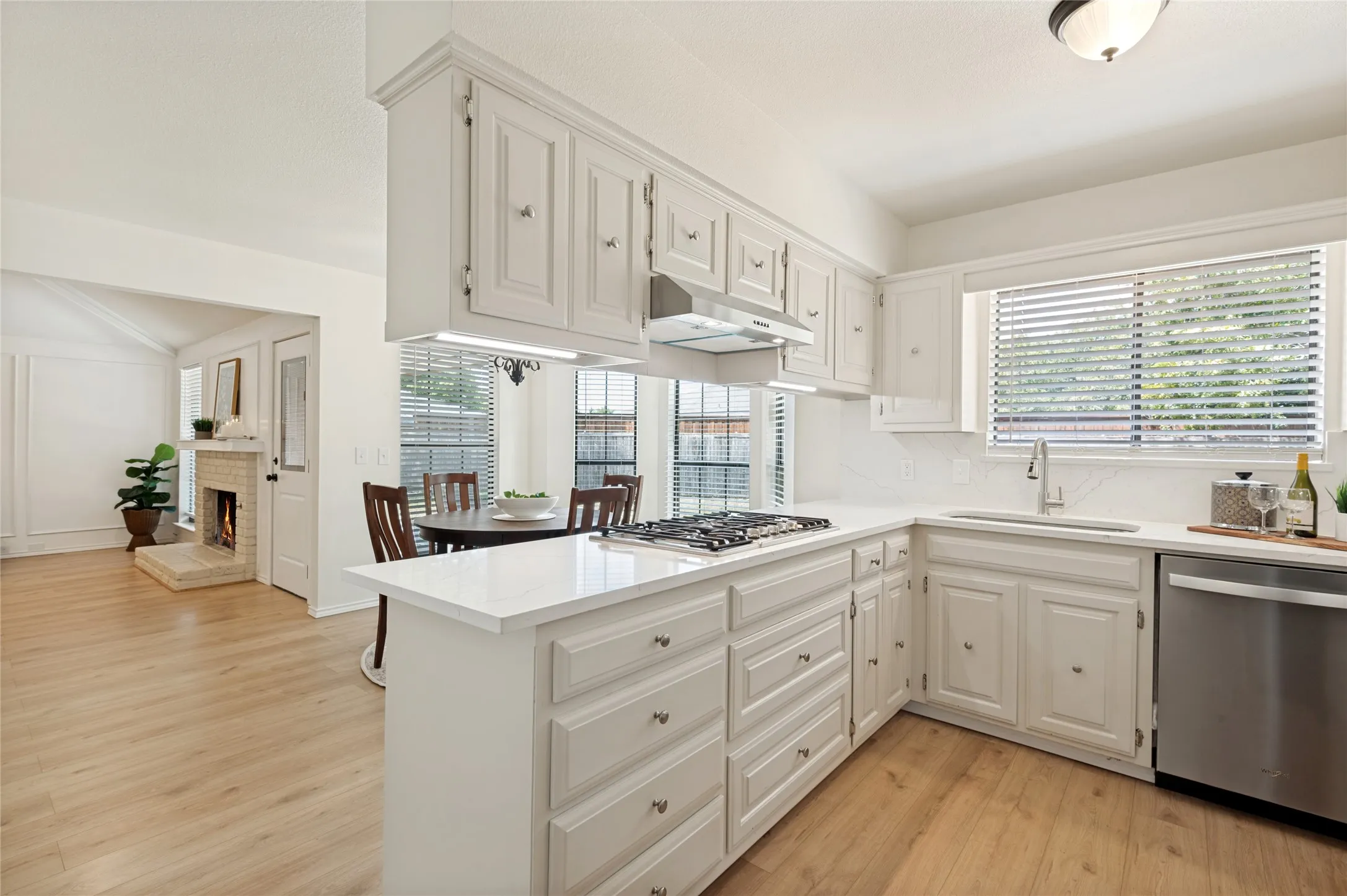 Beautifully-updated kitchen, eat-in dining, and open concept into the living area providing views into the oversized  backyard
