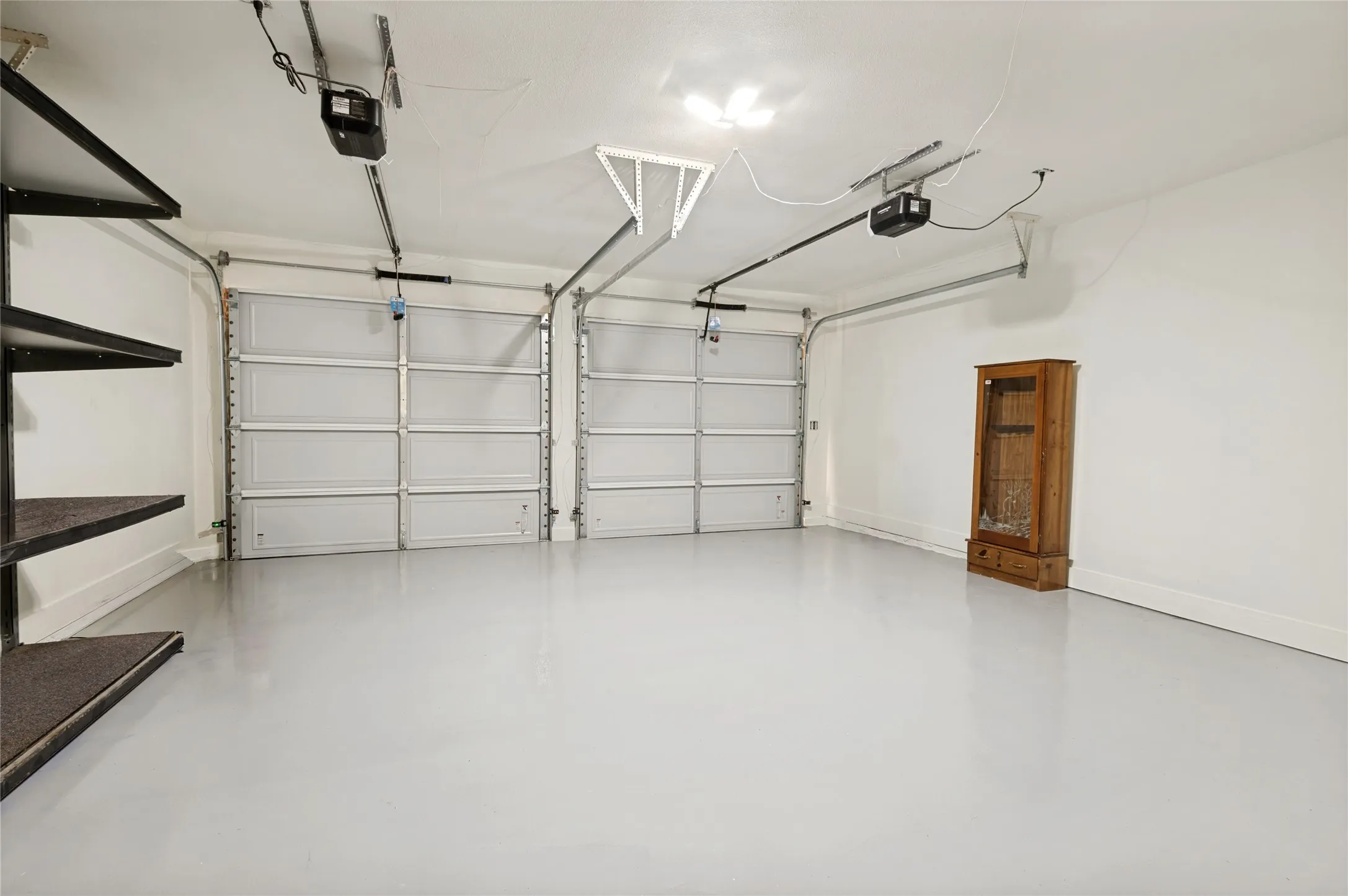 New Garage Epoxy floors with added shelf storage and front facing doors (2)