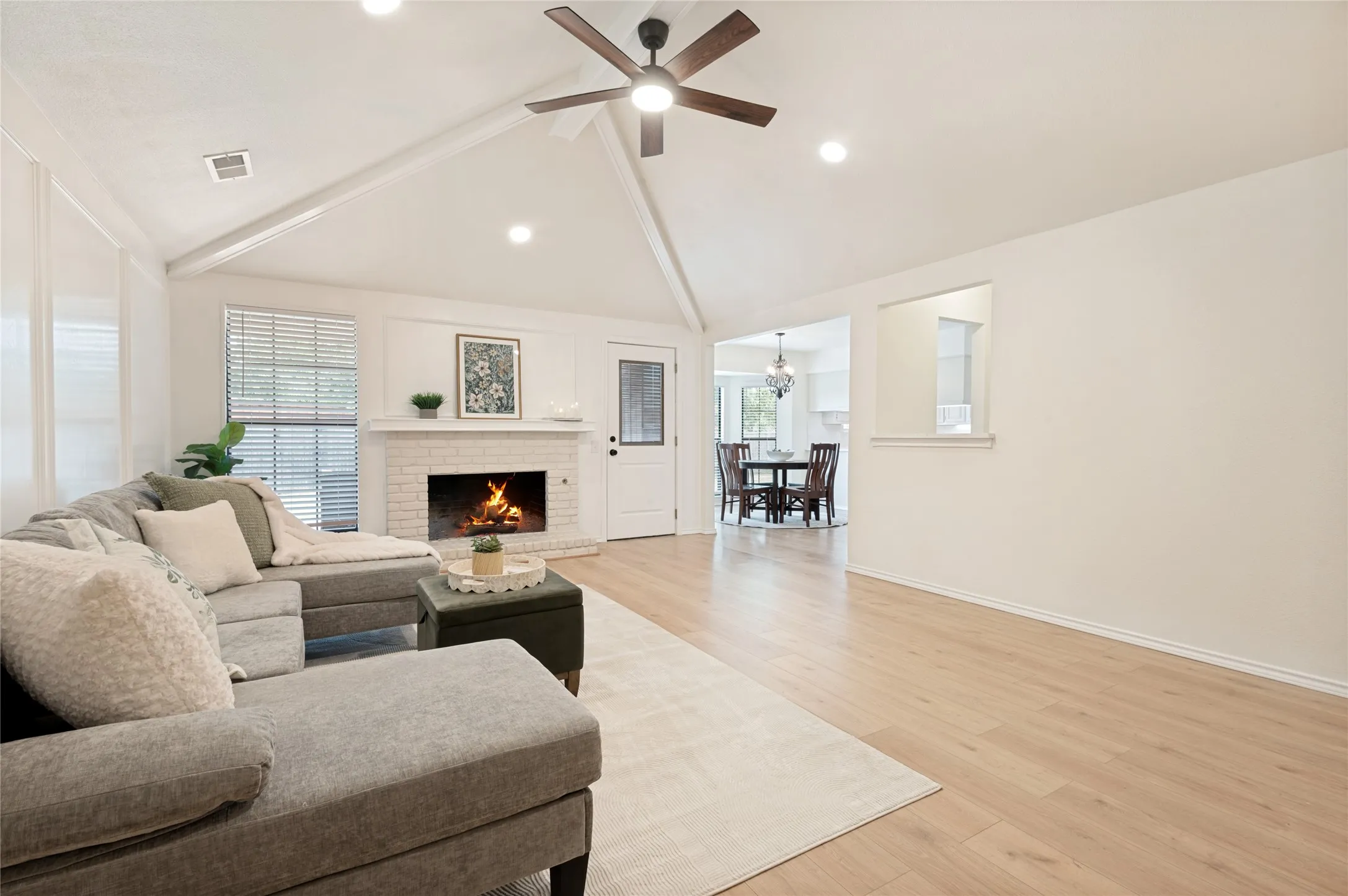 Open-concept view from the living room and into the wet bar, dining area, and the kitchen - a party planners ideal layout.