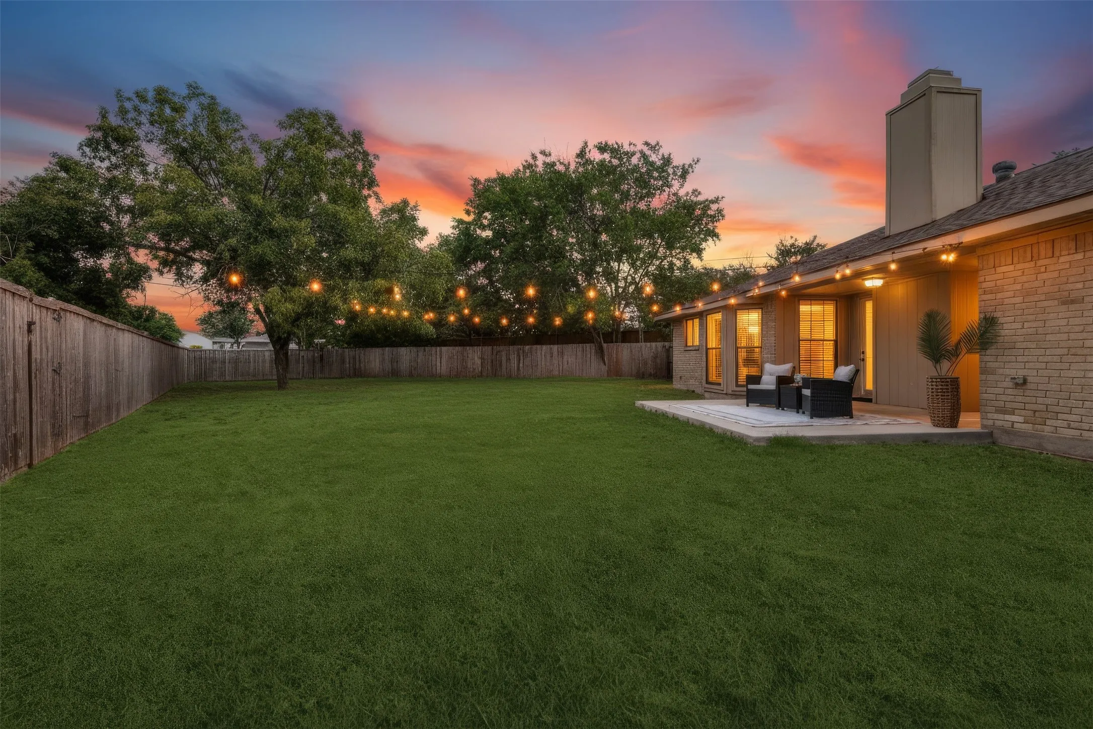 Backyard patio with a doorway leading into the entertainers' space and kitchen/dining room/wet bar
