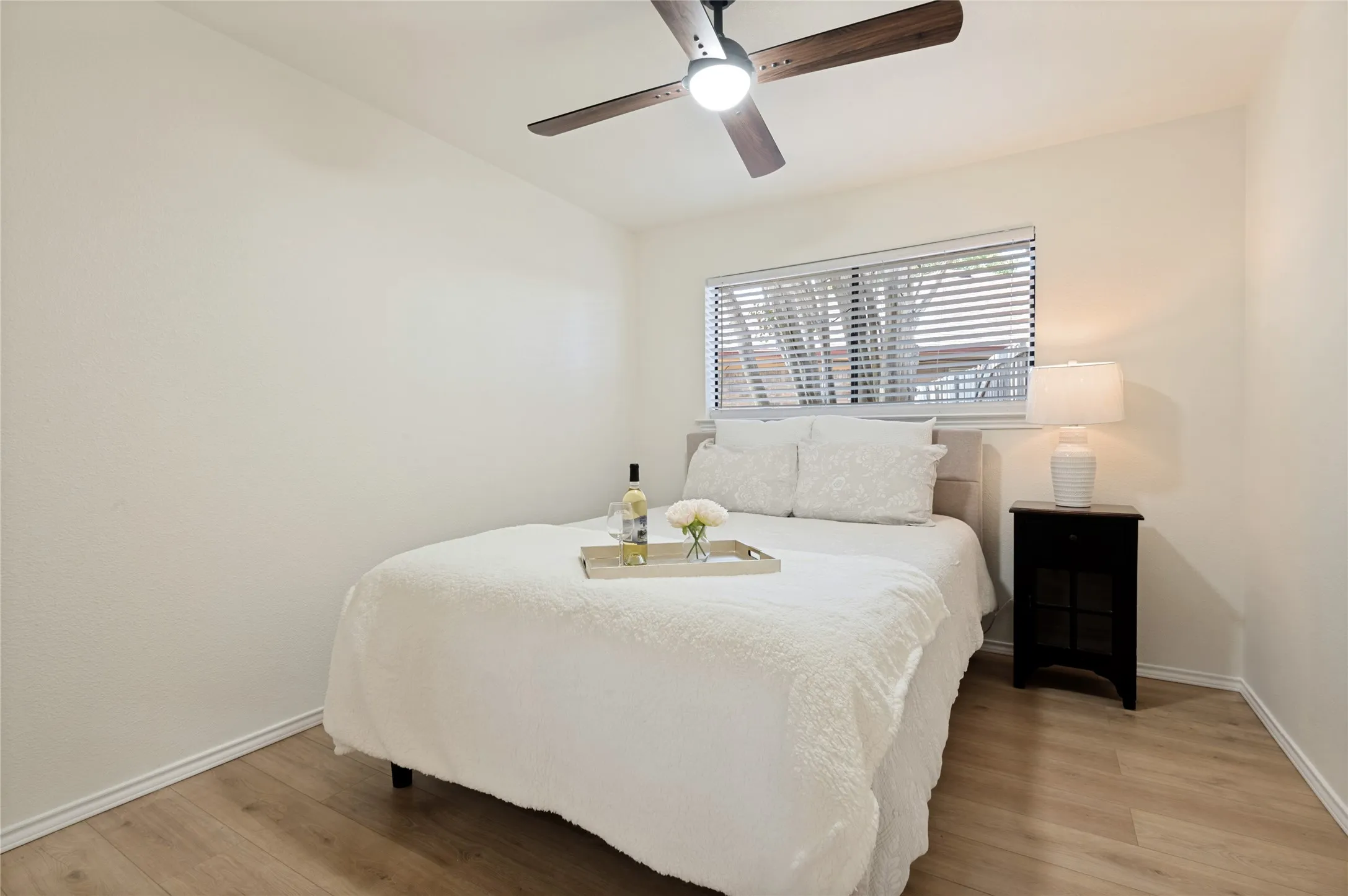 1 of 3 bedrooms with natural light into the side yard - this room has fresh paint, new floors/ceiling fan/window and a walk-in closet