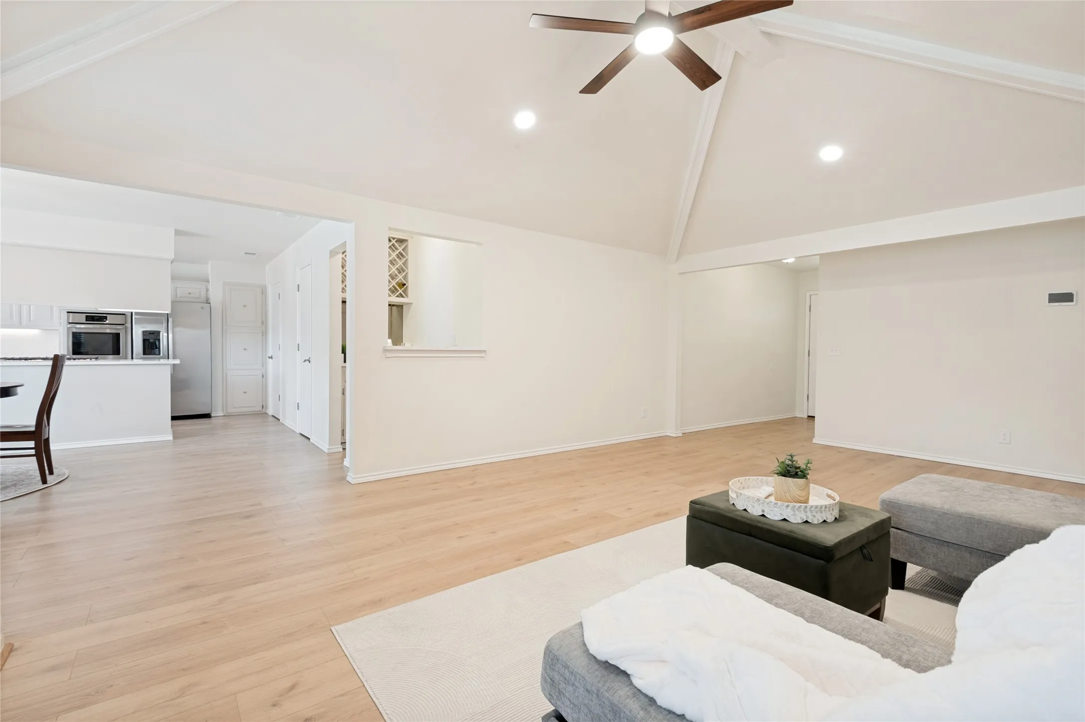 View from the living room into the separate wet bar, dining area, and kitchen