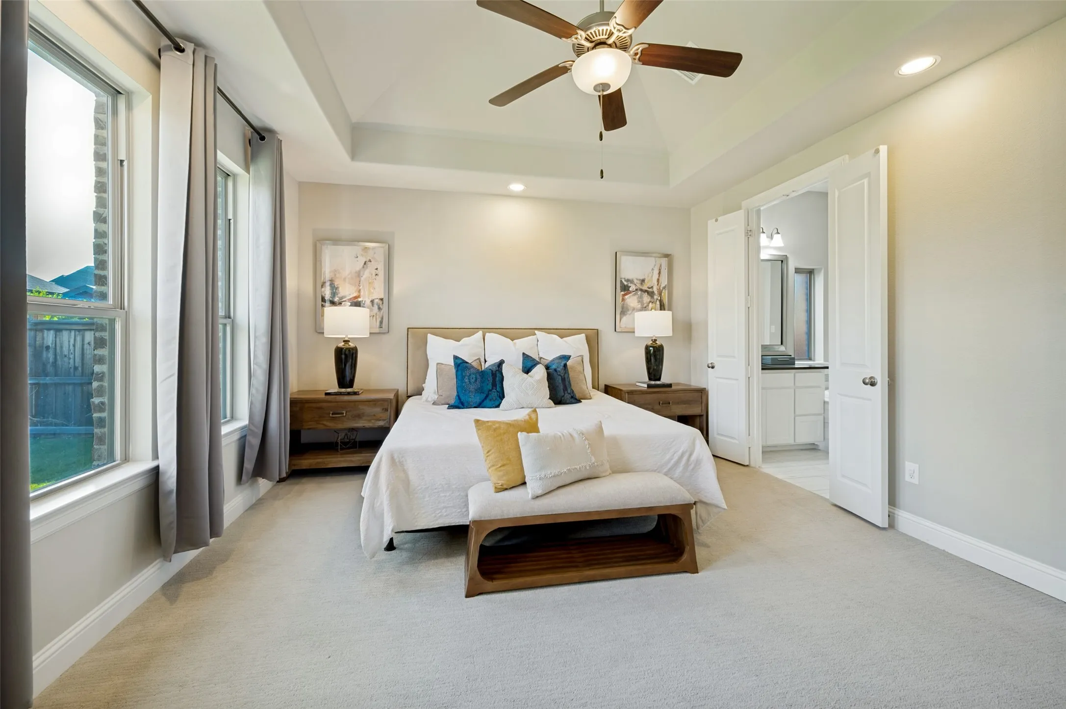 The private primary suite is a true retreat, featuring a tray ceiling, soft natural light, and a spacious layout designed for both comfort and sophistication. With direct access to the luxurious ensuite bath, this serene sanctuary offers the perfect balance of elegance, privacy, and everyday relaxation.