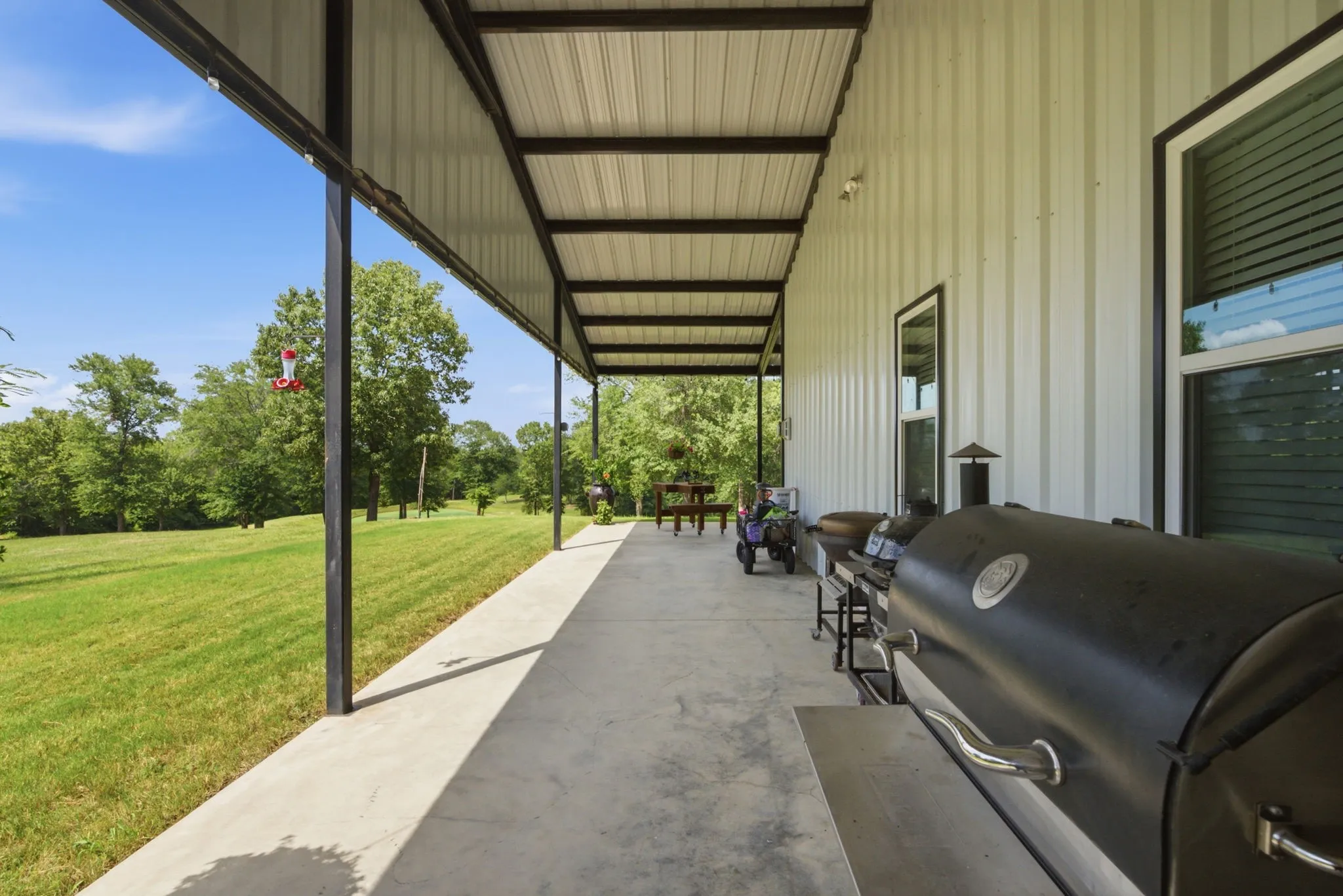 Expansive covered patio featuring a concrete surface and a metal roof structure