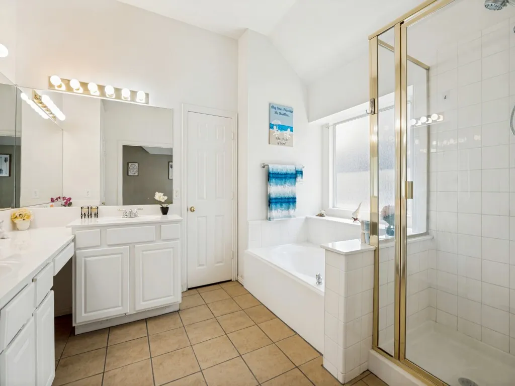 Primary bathroom with separate shower, walk-in closet