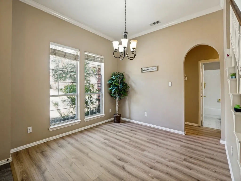 Another view point of formal dining leading to guest bath & 2 secondary bedrooms
