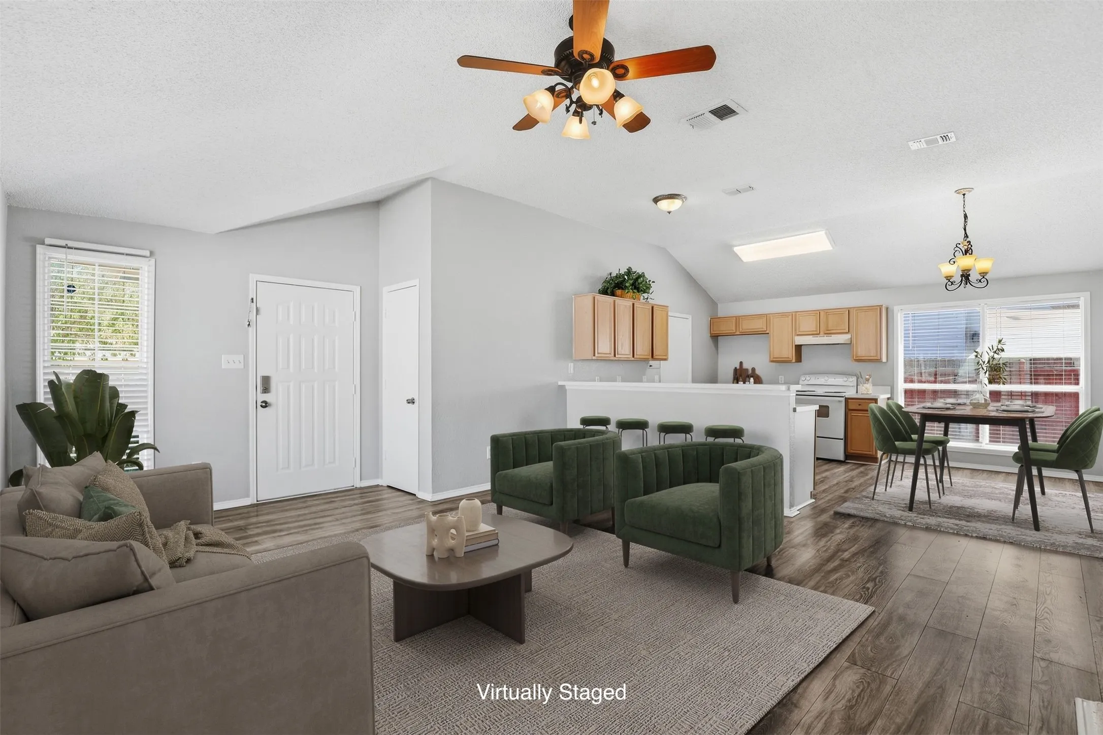 Vaulted ceiling with a ceiling fan, wood-finish flooring, recessed lighting, and a white paneled entry door