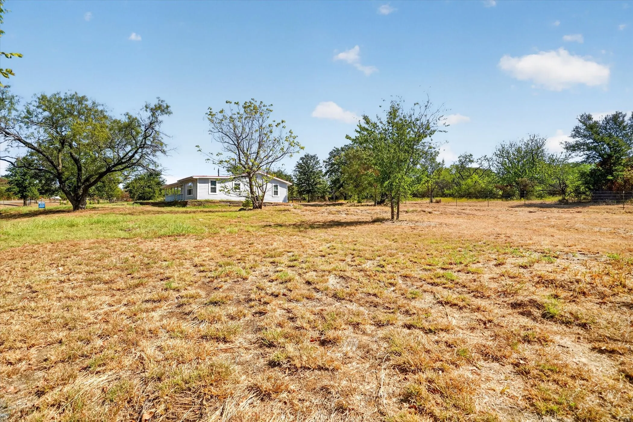 Expansive lot with mature trees and a single-story residence