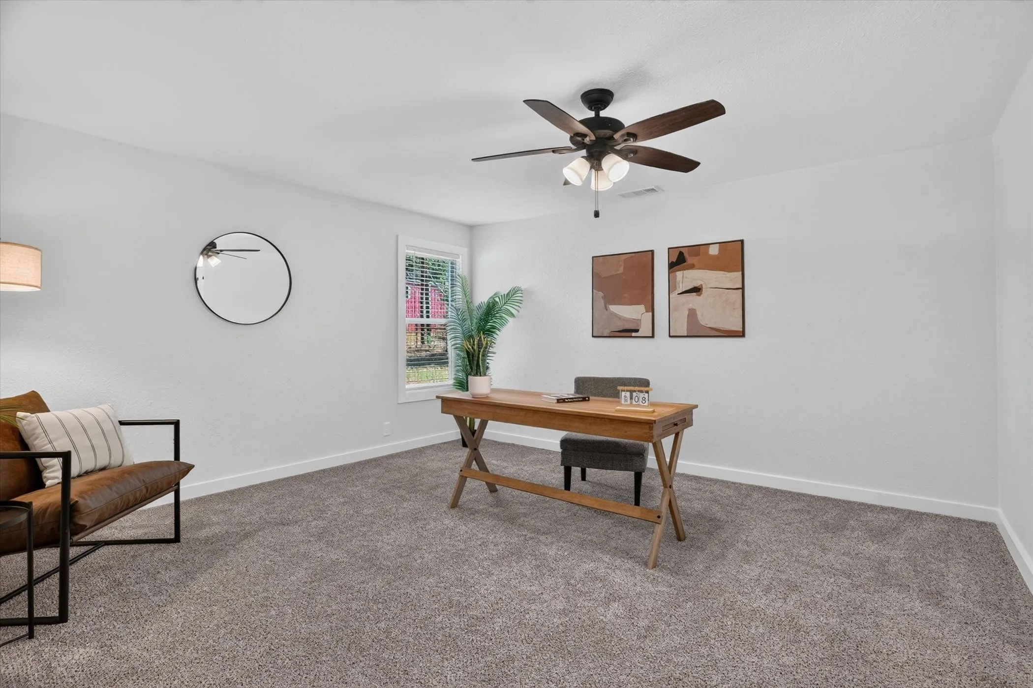 Carpeted flooring, a window with natural light, and a ceiling fan with integrated lighting