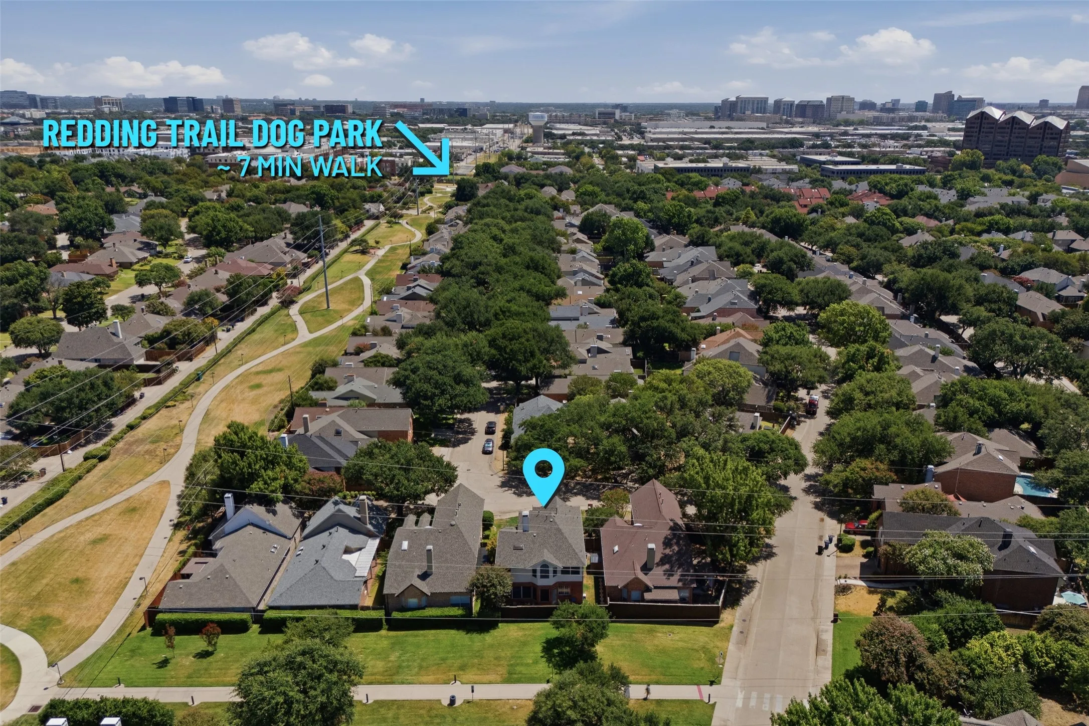 Just a short 7-minute walk from the front door, Redding Trail Dog Park offers a fully fenced off-leash area for your four-legged family members. This aerial view shows the home's proximity to the trail system and the larger Addison community, with the city skyline visible on the horizon