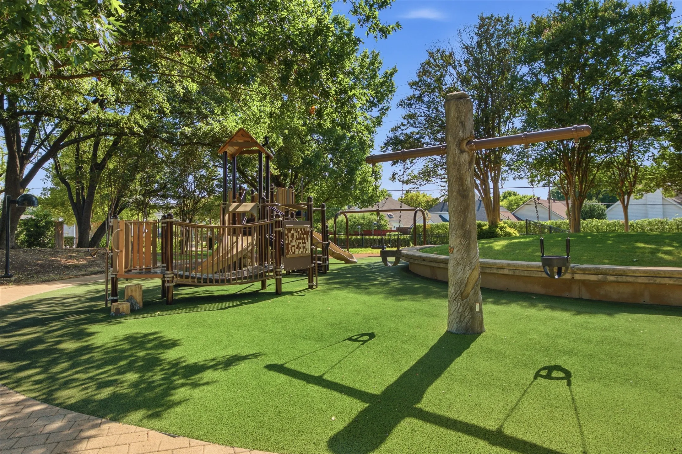 The beautiful Dome Park Playground features natural wood-themed play equipment, swings, and artificial turf — all tucked under a canopy of mature shade trees. At just a 2-minute walk, it's one of the best perks of living at 3903 Rive.