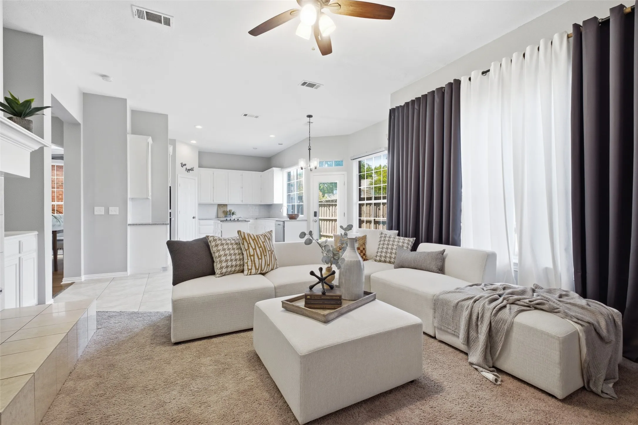 Generous windows flood the family room with natural light while framing a direct view into the kitchen and out to the backyard. The open layout keeps everyone connected whether you're cooking, relaxing, or hosting.